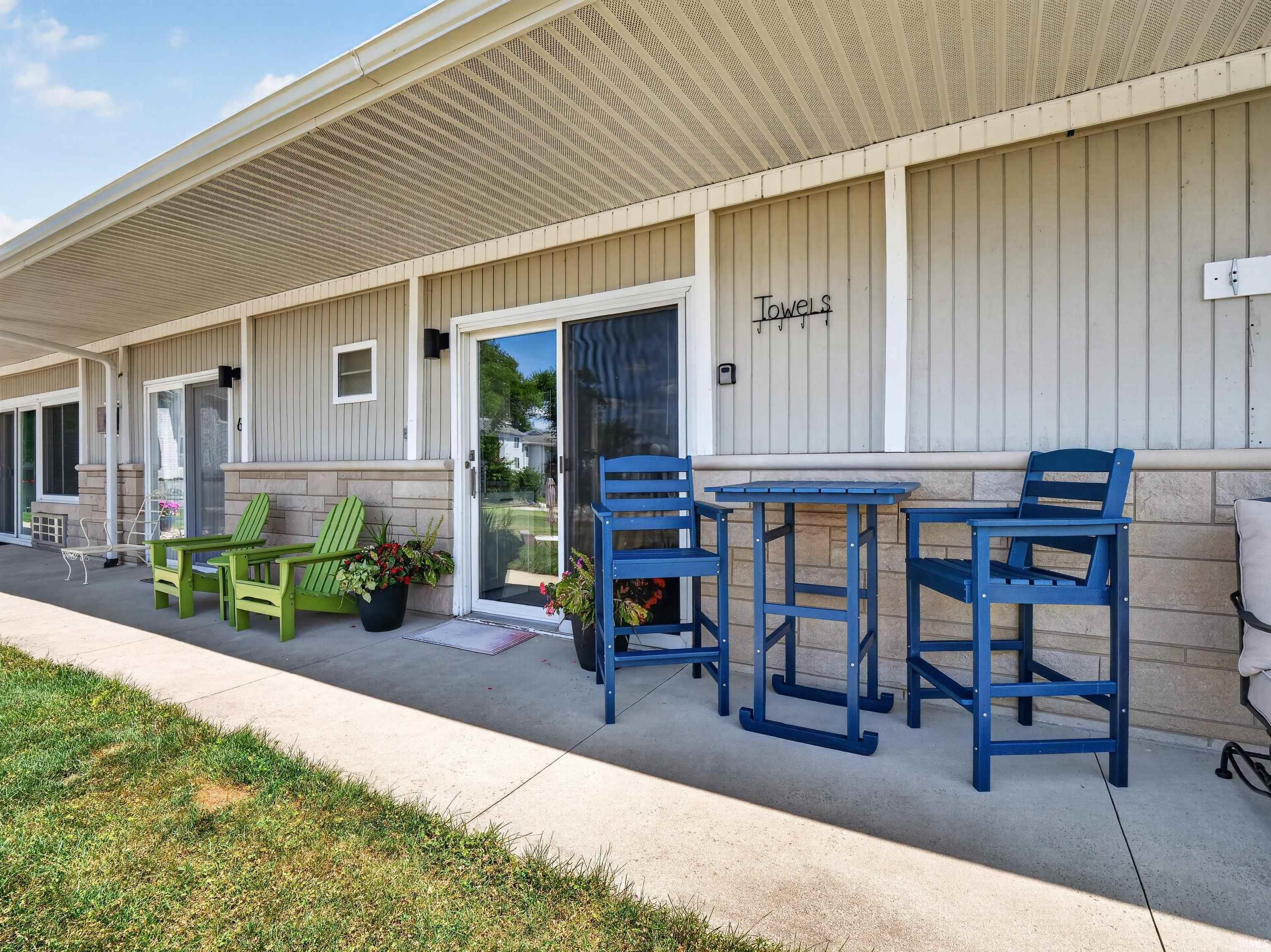 Covered patio area featuring a concrete slab and vertical siding