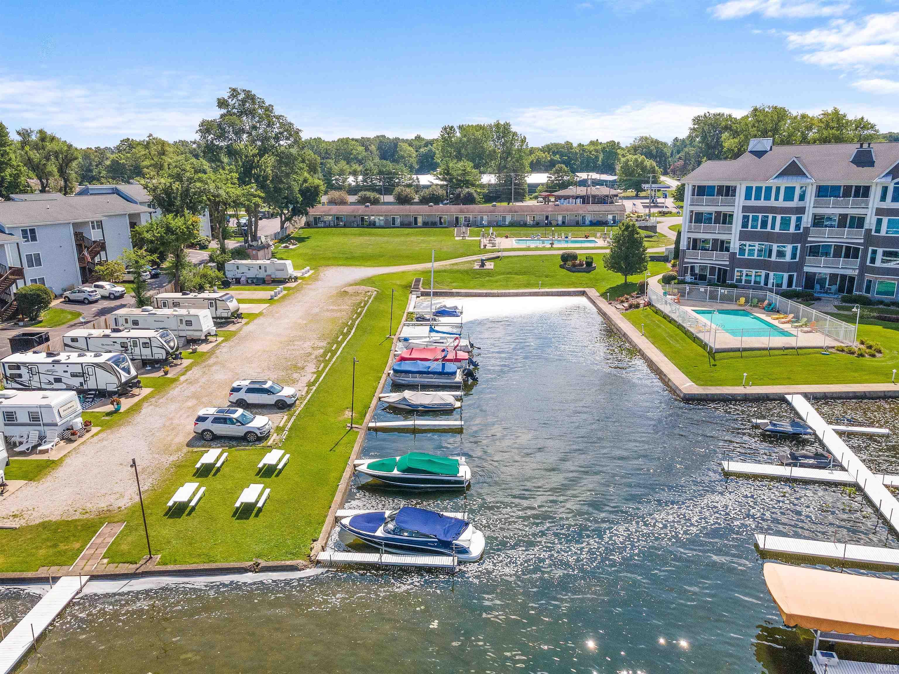 Marina with boat slips, adjacent green spaces, and a swimming pool