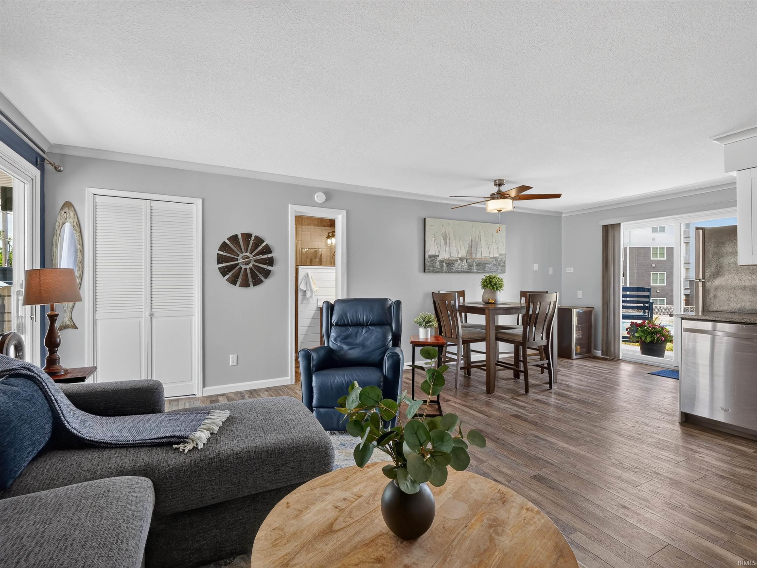 Expansive open concept living area featuring wood-finish flooring, light gray wall paint, and white trim