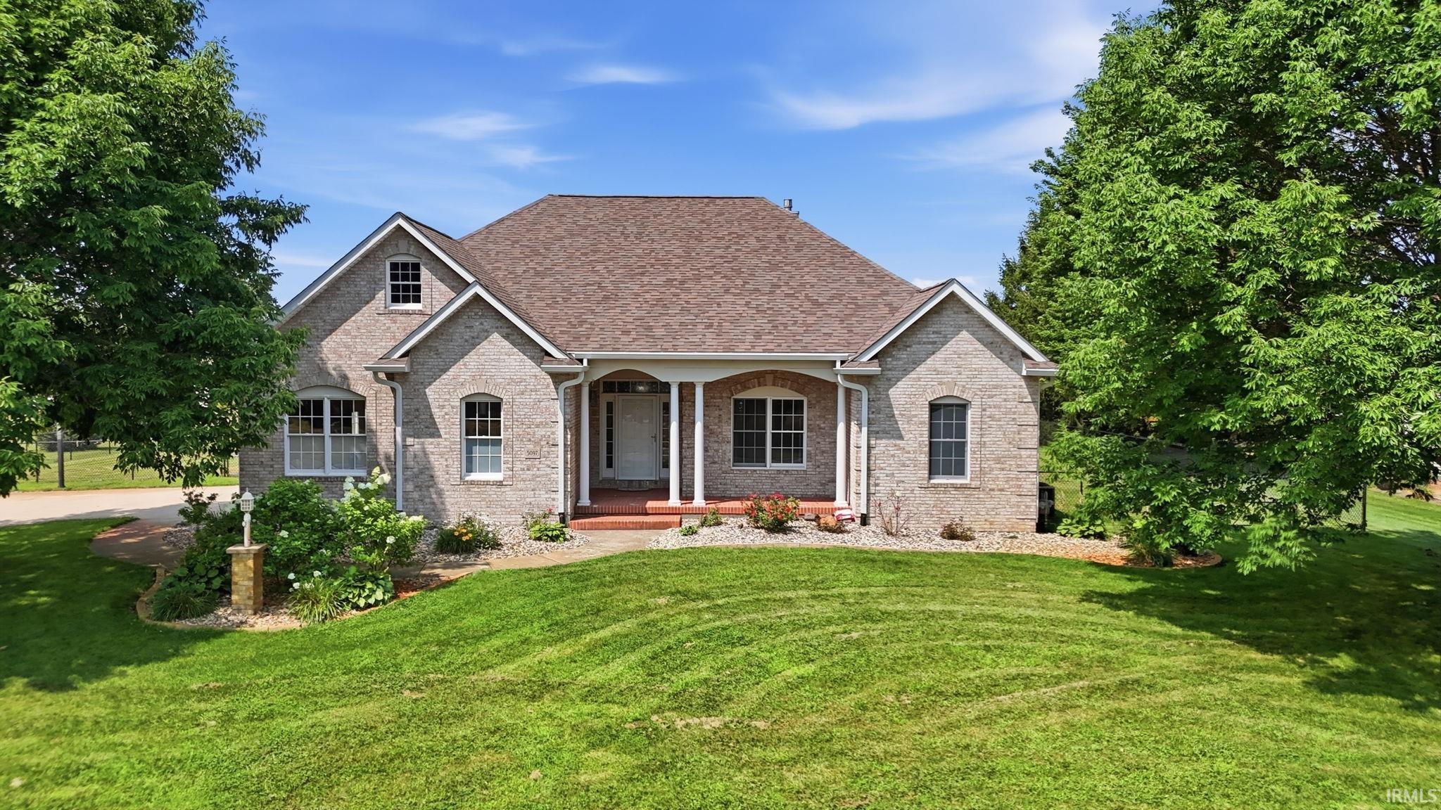 Brick exterior with a gabled roof and covered front porch