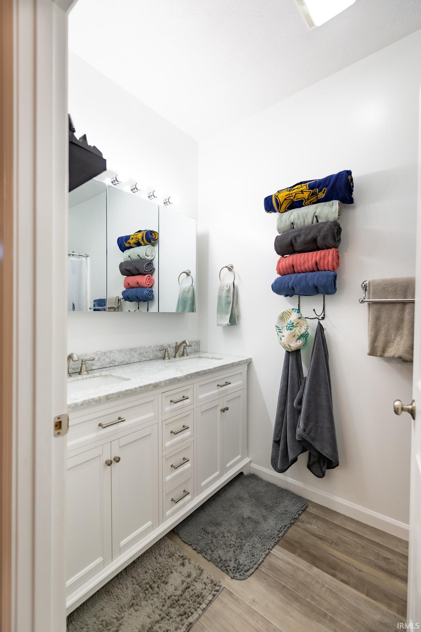 Dual vanity featuring white shaker cabinetry, brushed nickel hardware, and a light-toned countertop with integrated sinks