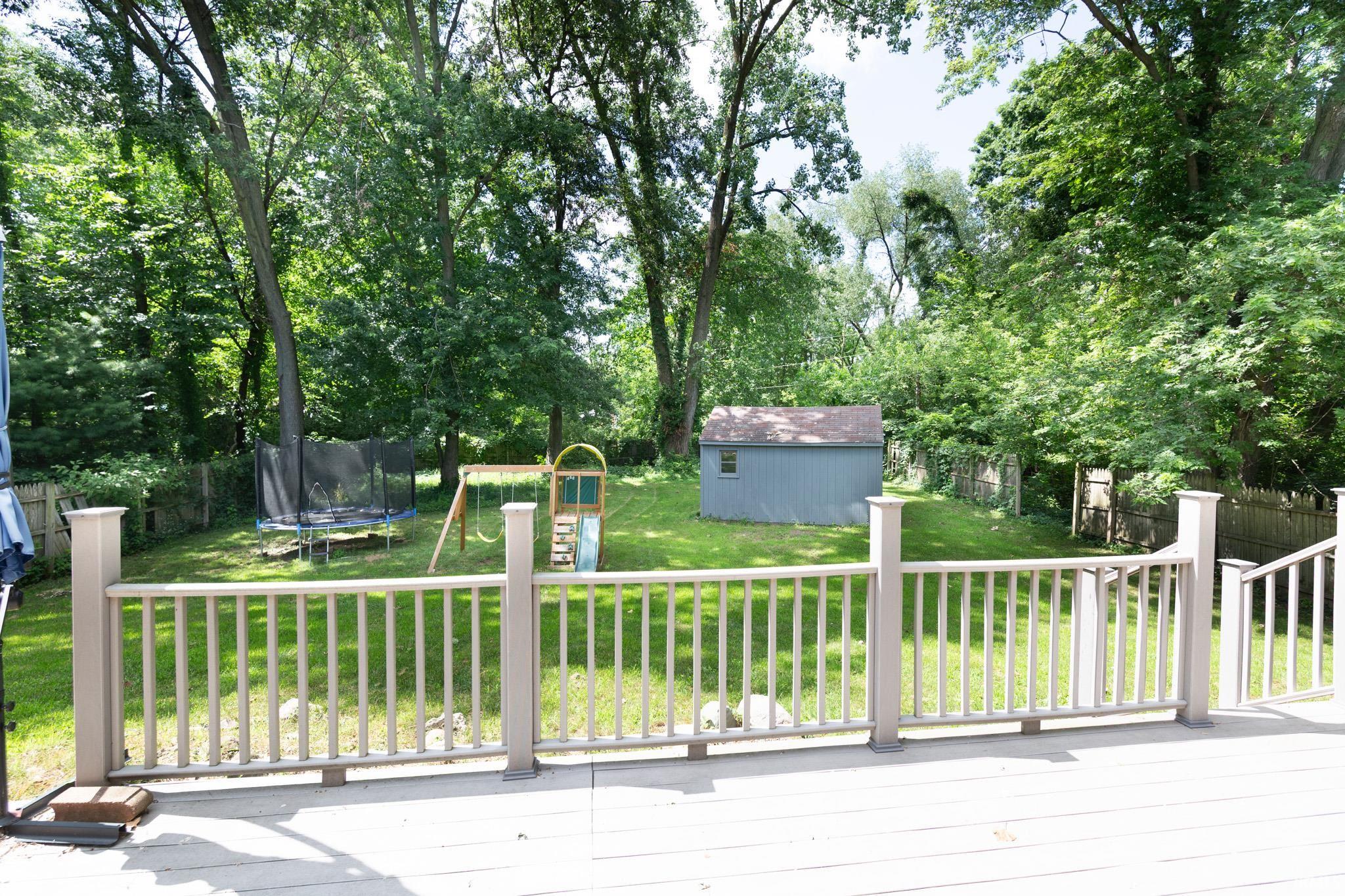 Private backyard with a composite deck featuring a railing system