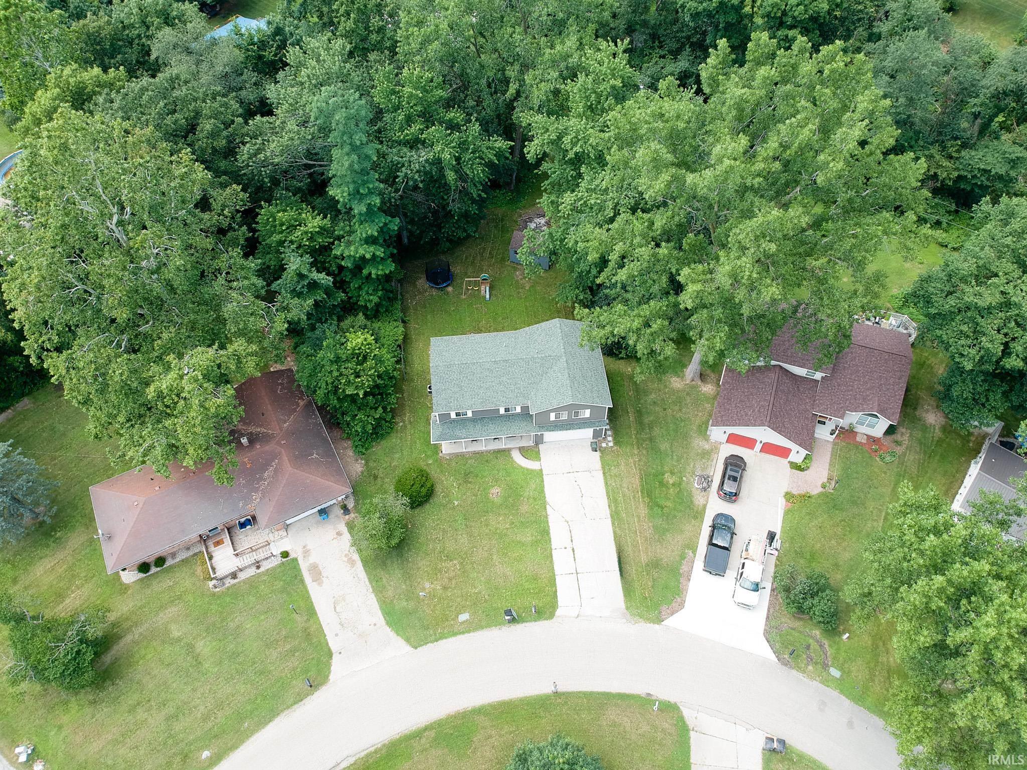 Aerial perspective showcasing a cul-de-sac location with three distinct properties