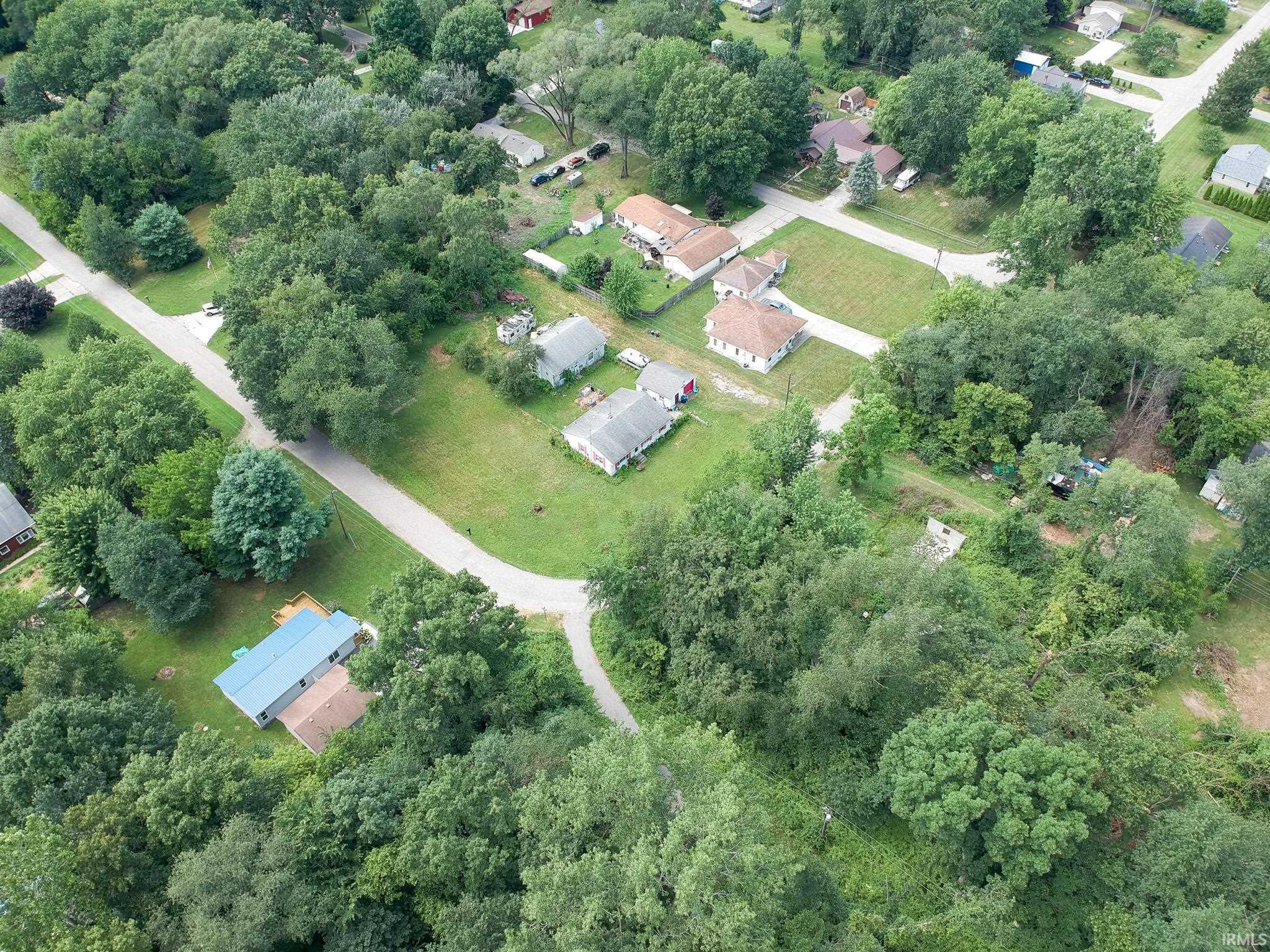 Aerial depiction of a residential area characterized by mature tree coverage