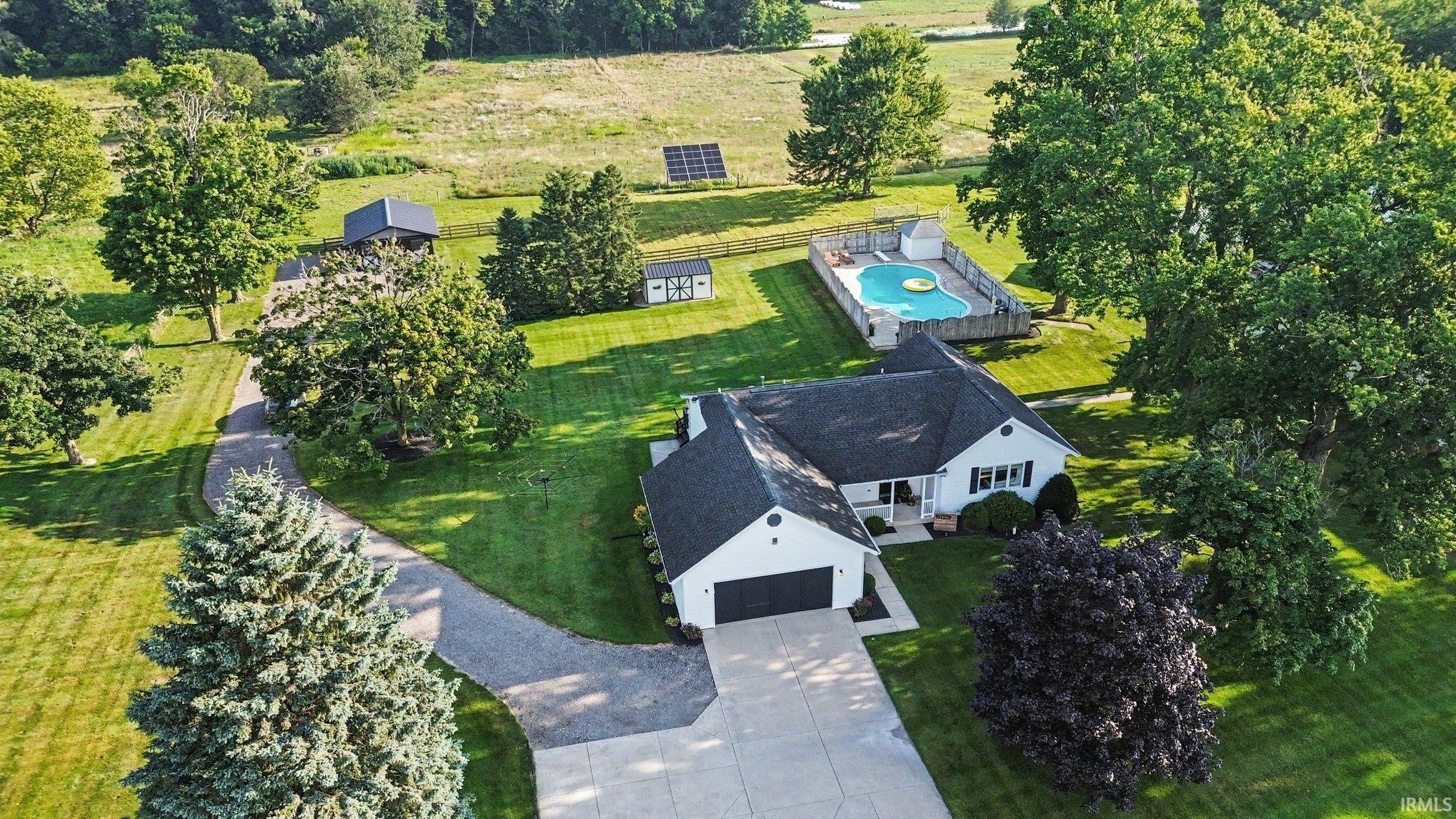 Single-story residence with attached garage, featuring a private inground swimming pool