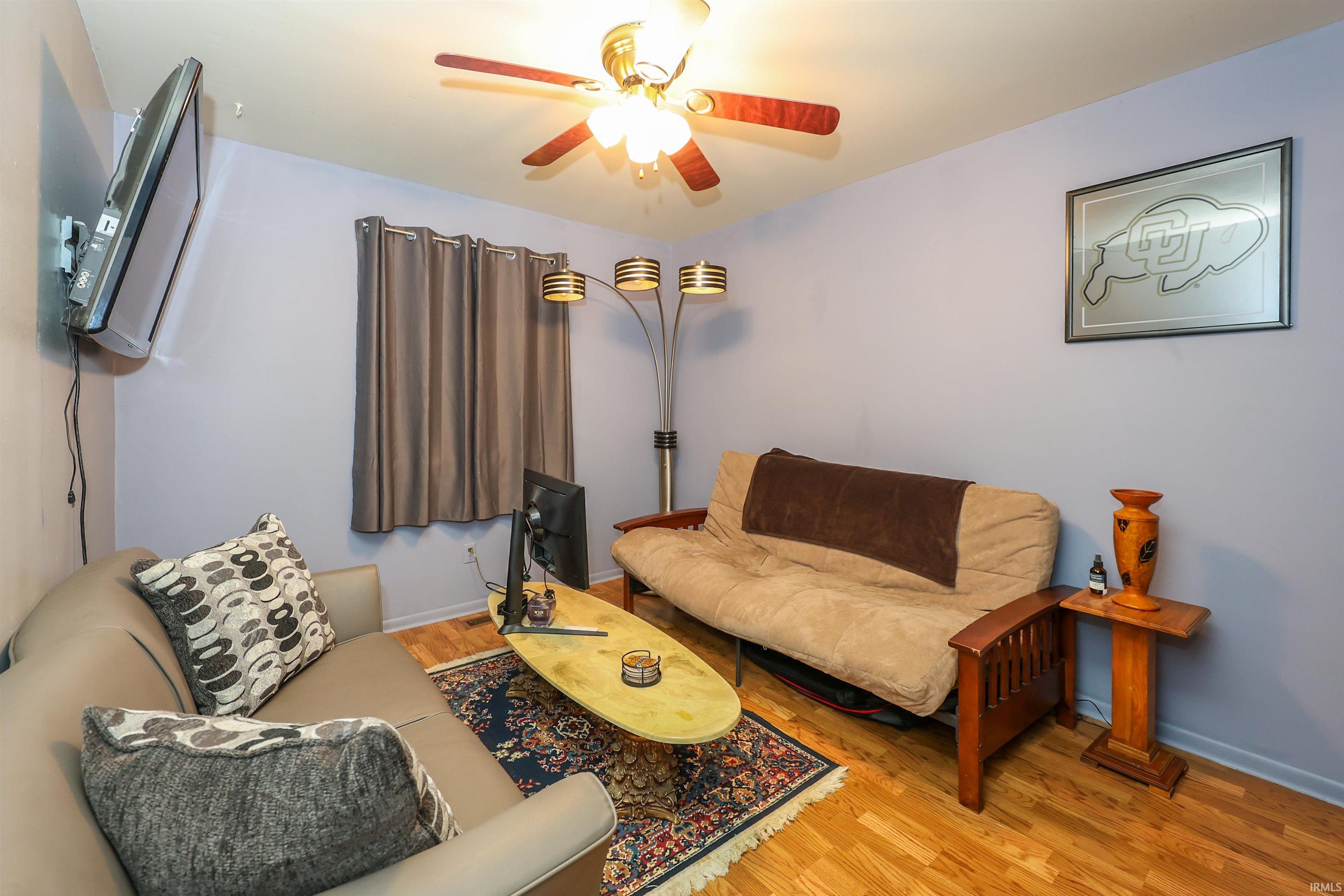 Light wood-finish flooring complements the neutral wall color in this versatile room