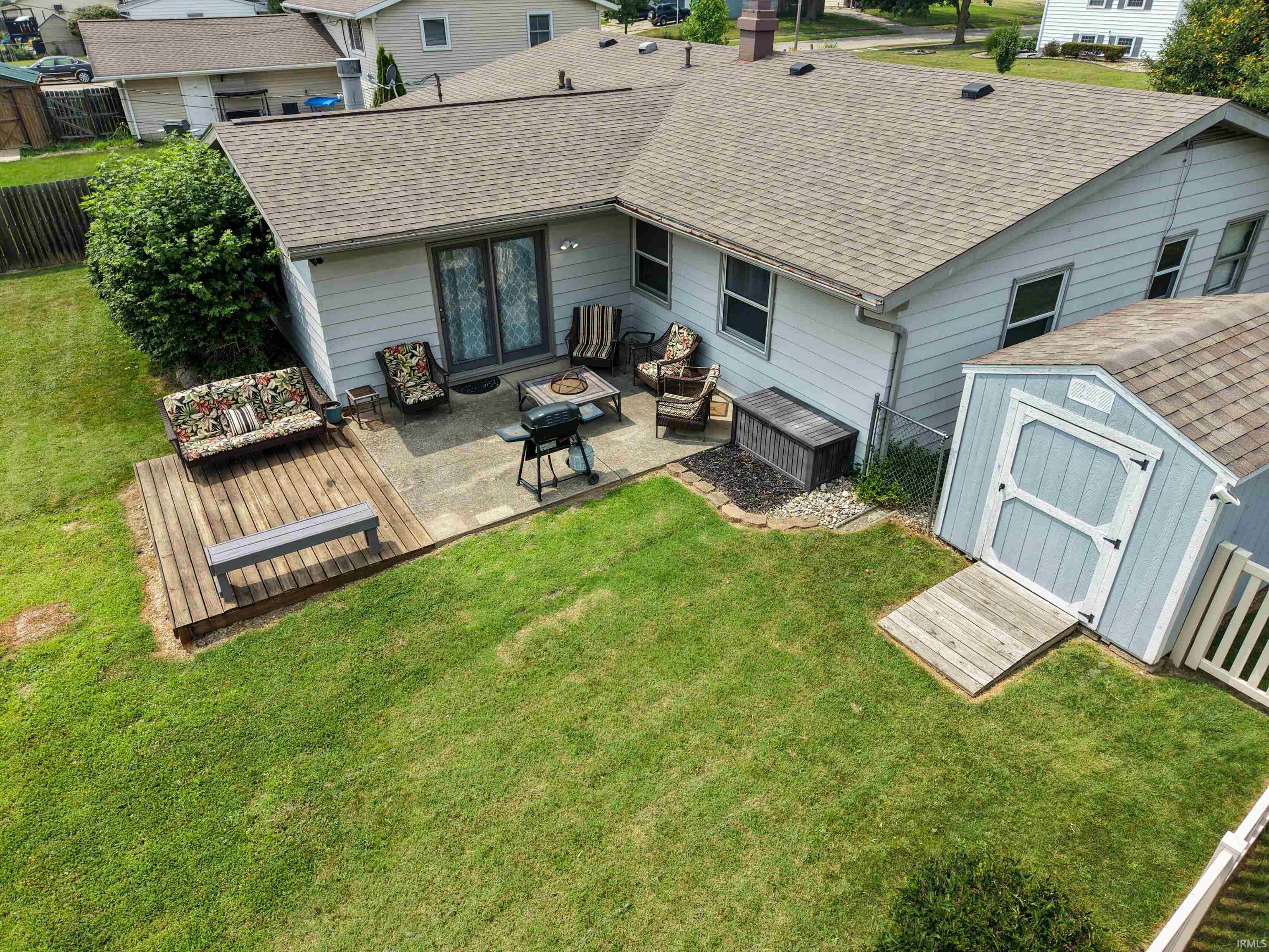 Expansive backyard featuring a combination concrete patio and wood deck