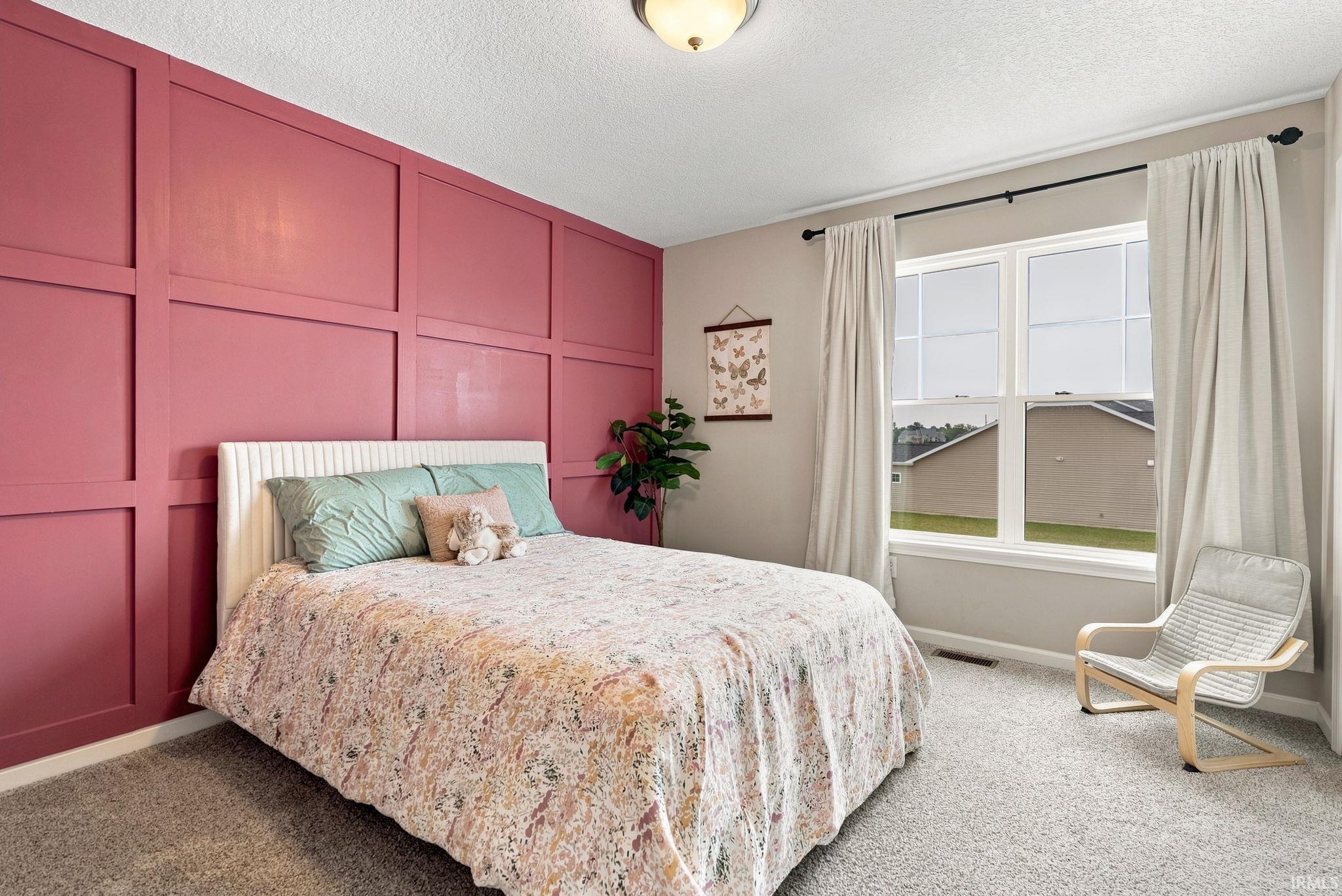 Accent wall featuring decorative millwork paneling