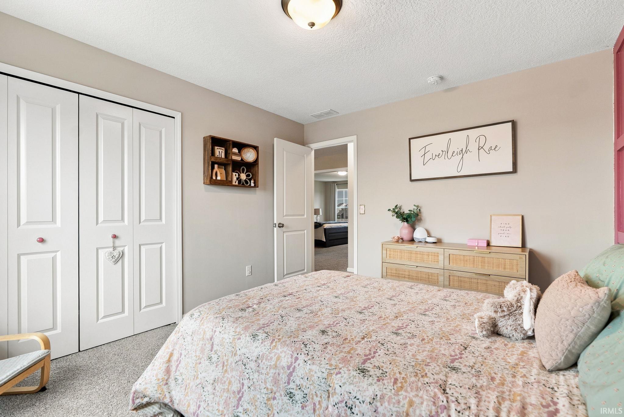 Bedroom featuring neutral wall paint, white bi-fold closet doors, and recessed ceiling lighting