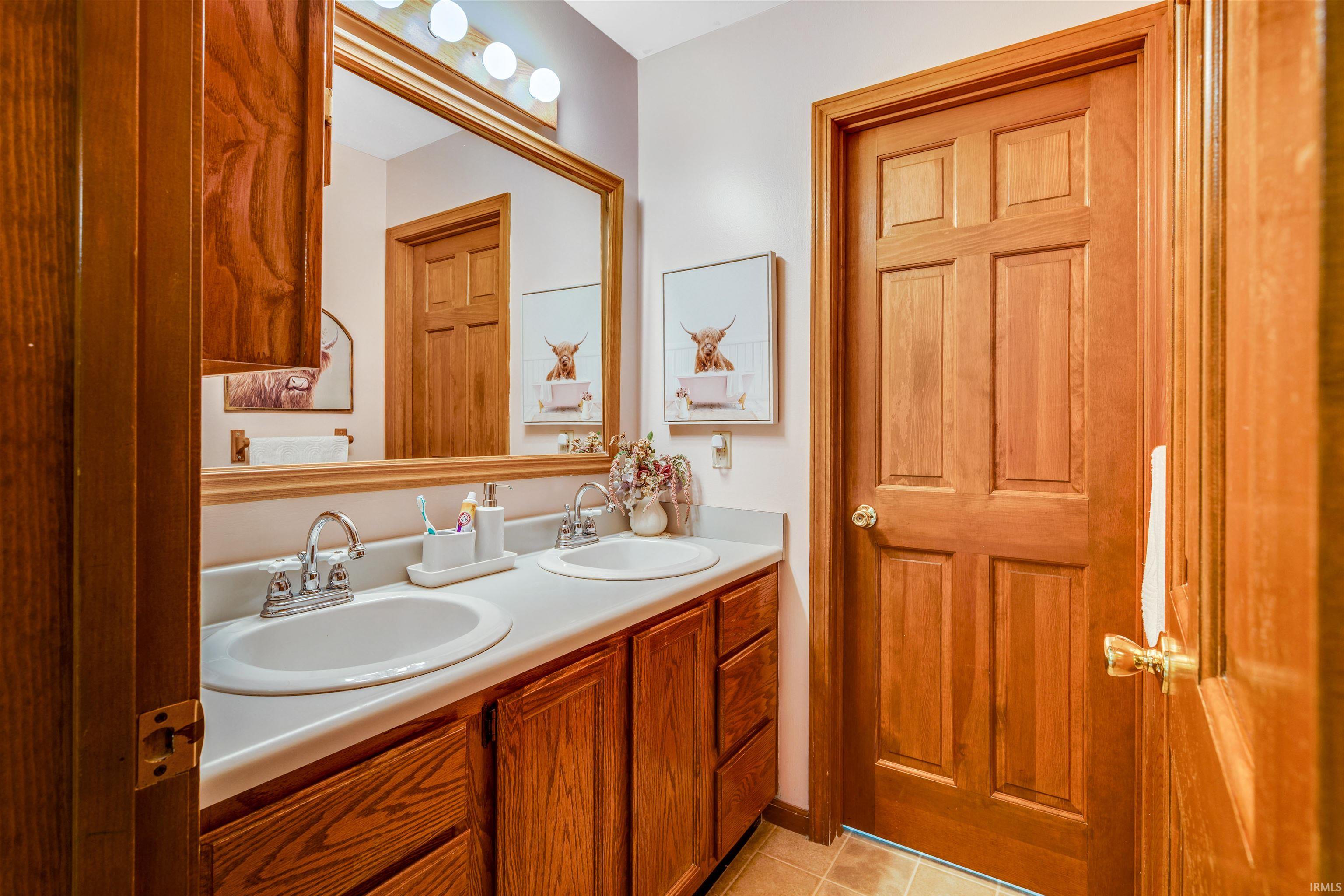 Double vanity featuring two sinks and chrome faucets