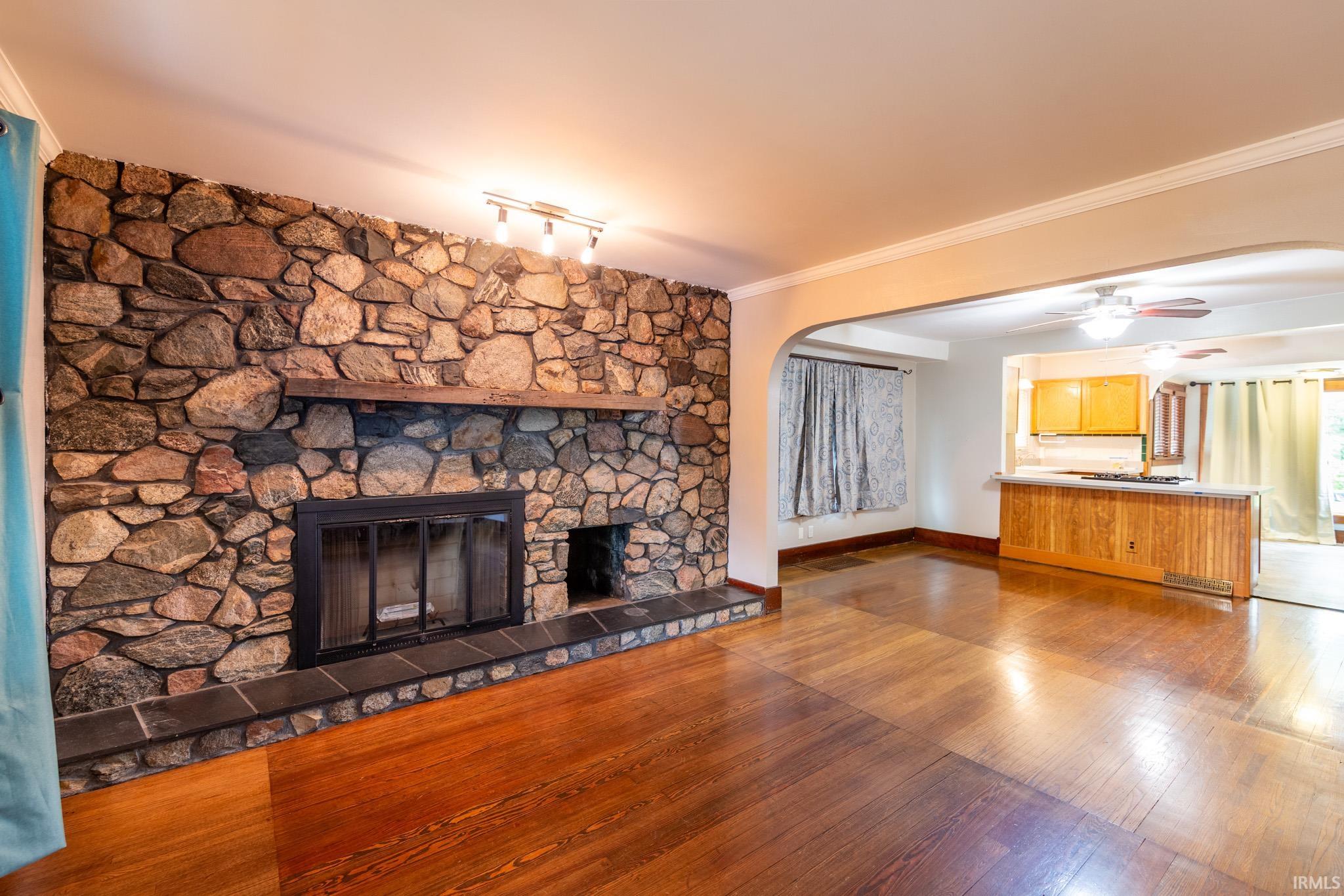 Stone fireplace featuring a wood mantel