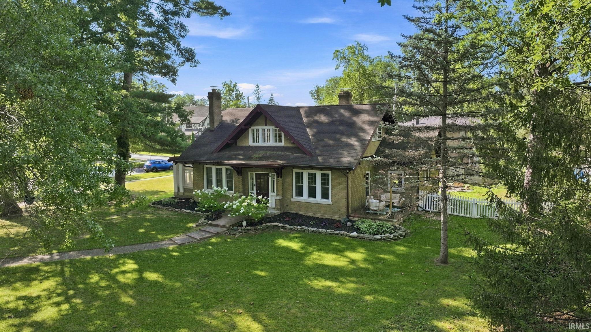 Craftsman-style residence with a prominent gabled roofline and exposed rafter tails
