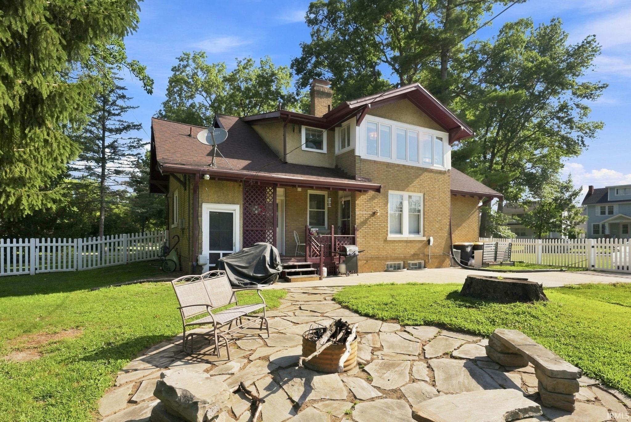 Exterior features a stucco and brick facade with a prominent bay window