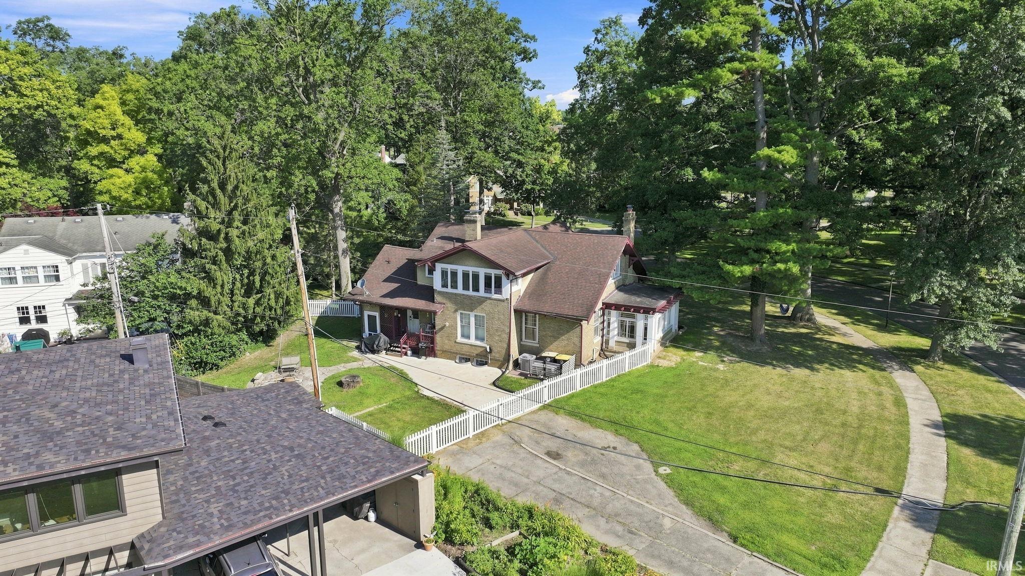 Traditional-style residence featuring a prominent brick exterior, gabled roofline, and a multi-pane window bay
