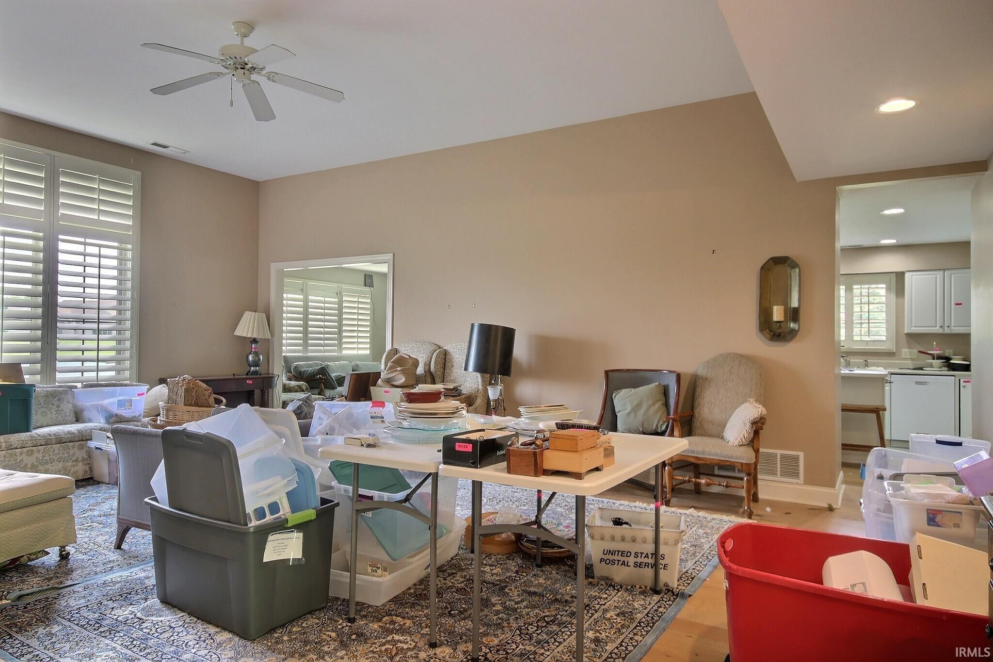 Spacious room with high ceilings, recessed lighting, and a ceiling fan