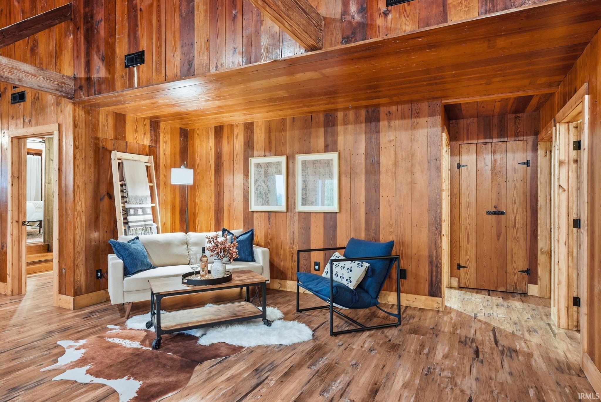 Wood-finish flooring throughout, complemented by wood paneling on walls and ceiling