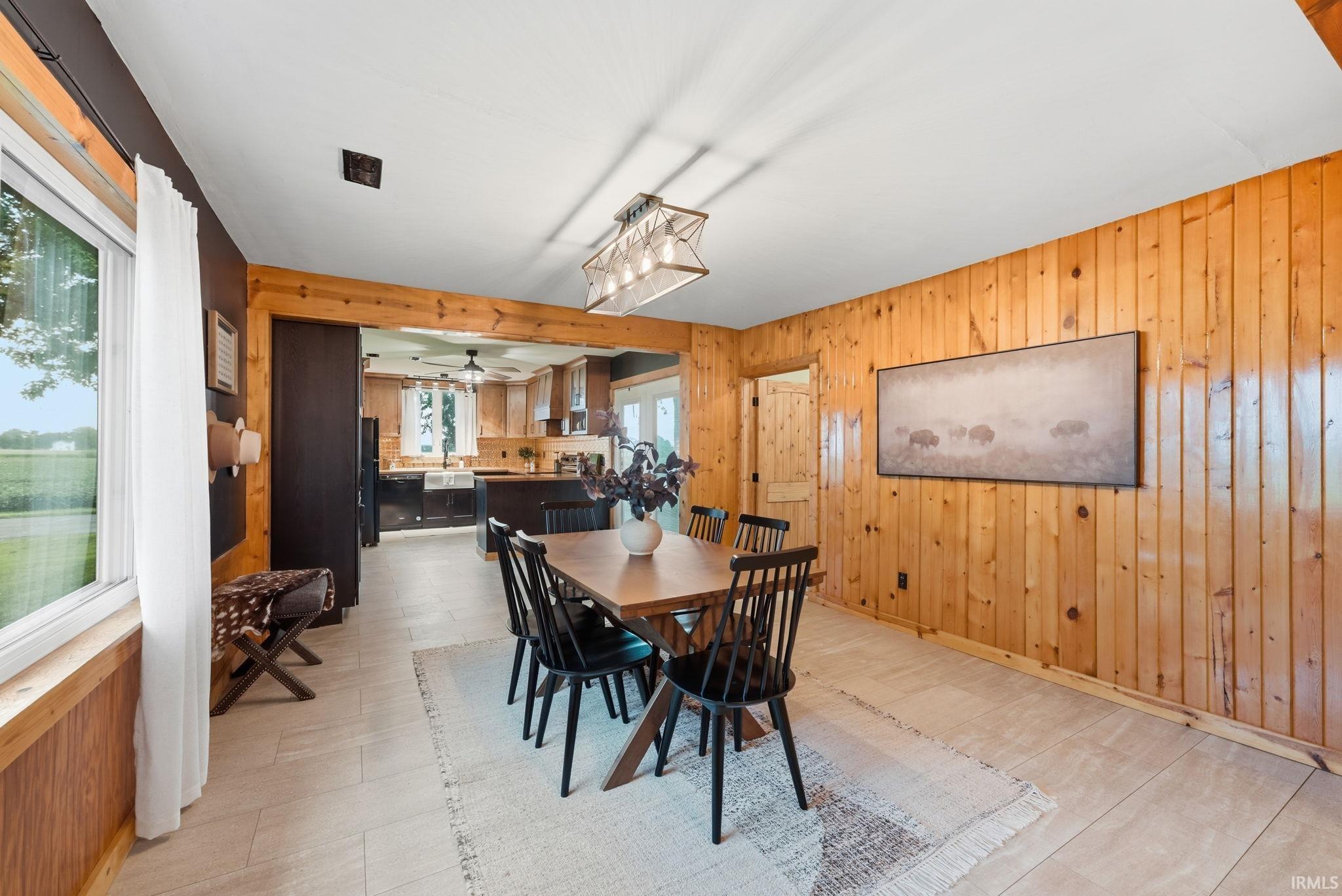 Wood-paneled wall, light-toned flooring, and a decorative overhead light fixture
