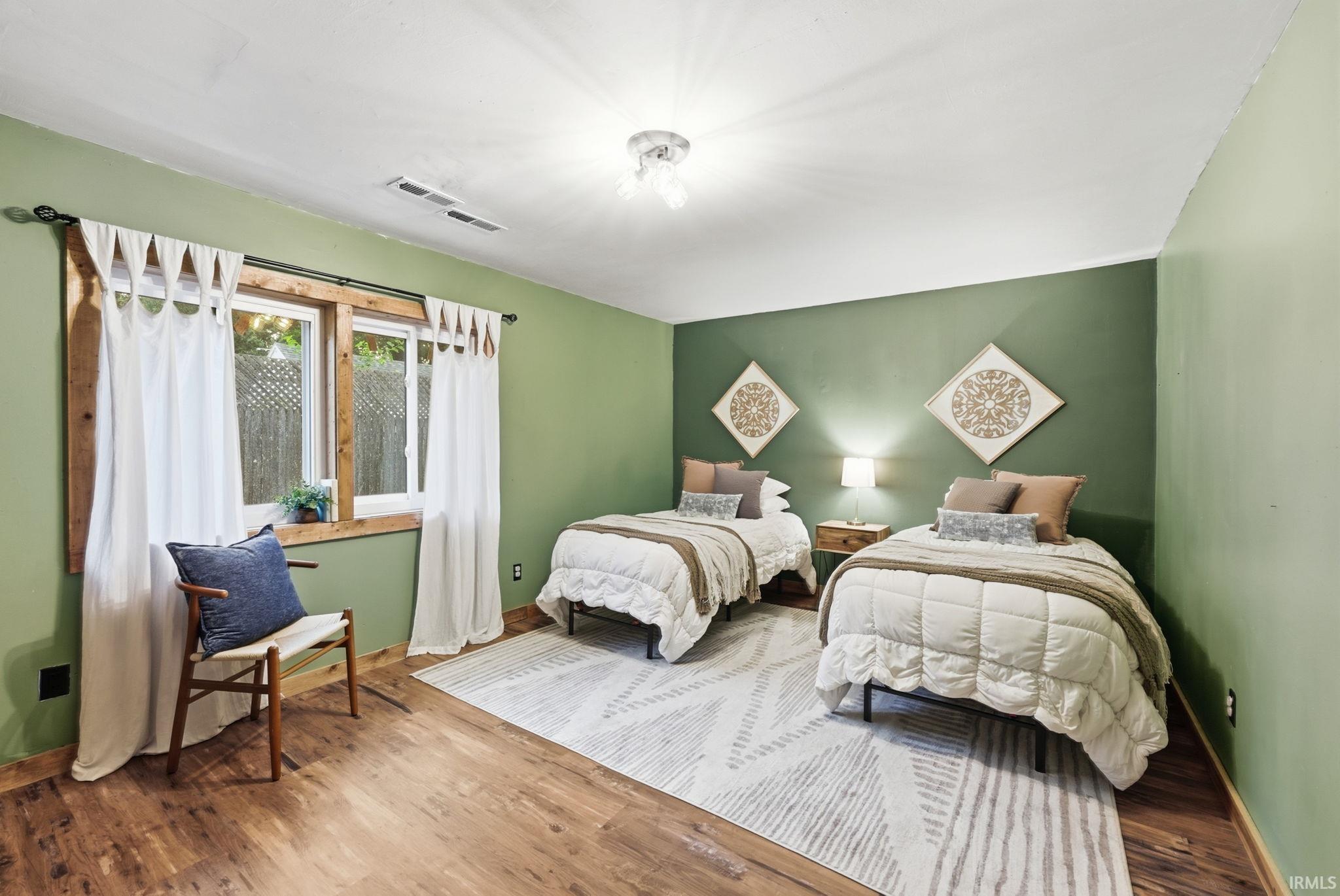 Wood-finish flooring, recessed lighting, and a window with wood trim