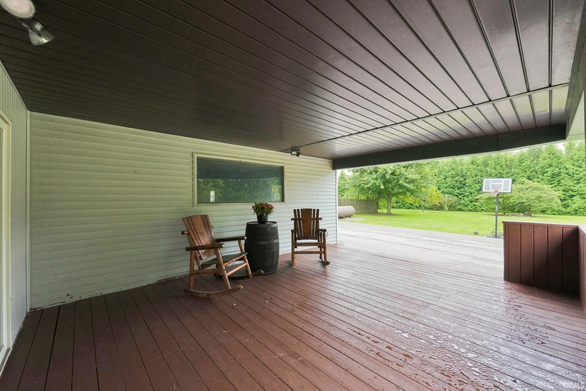 Covered outdoor deck with wood-finish flooring