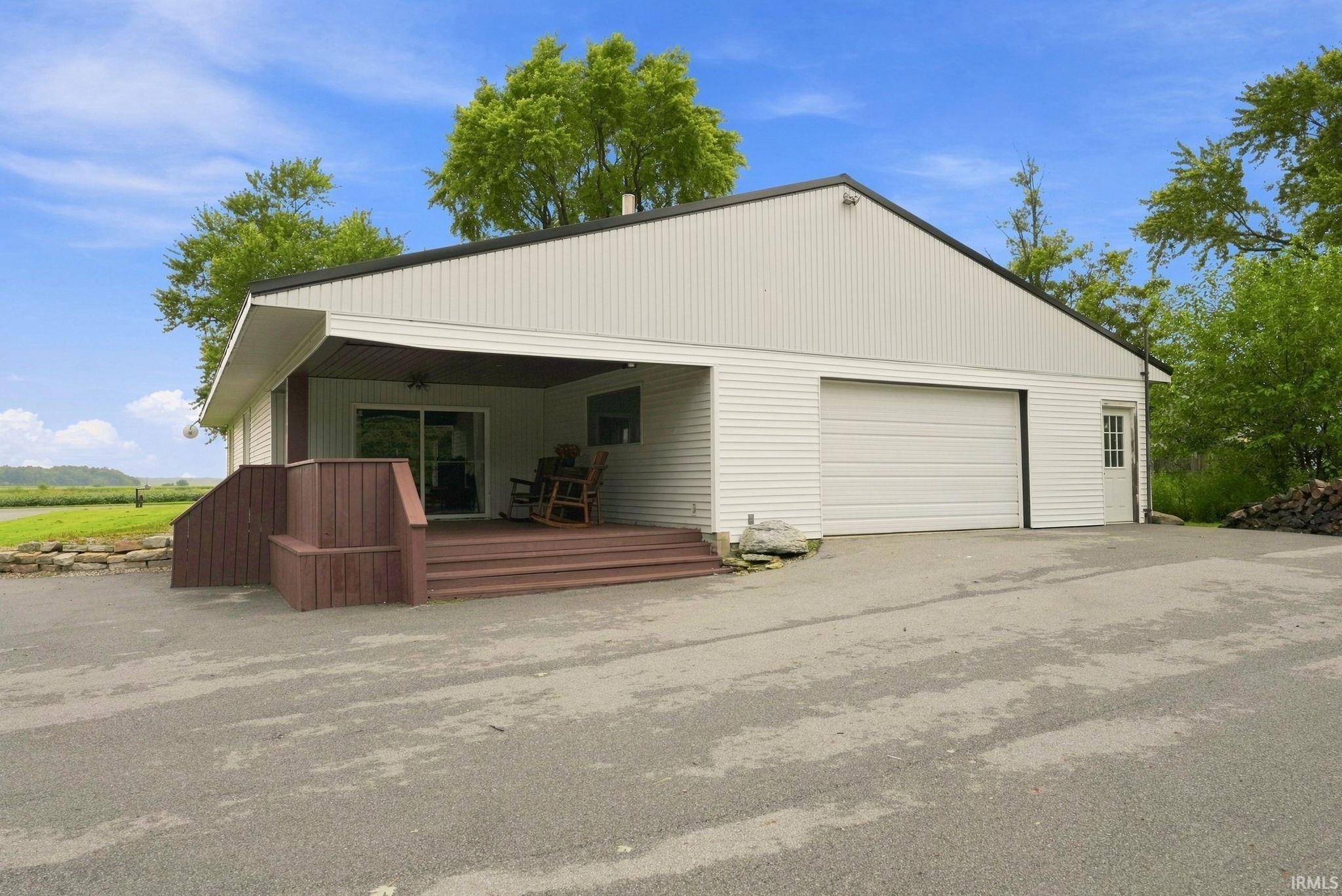 Light-toned siding exterior with a dark-toned roof