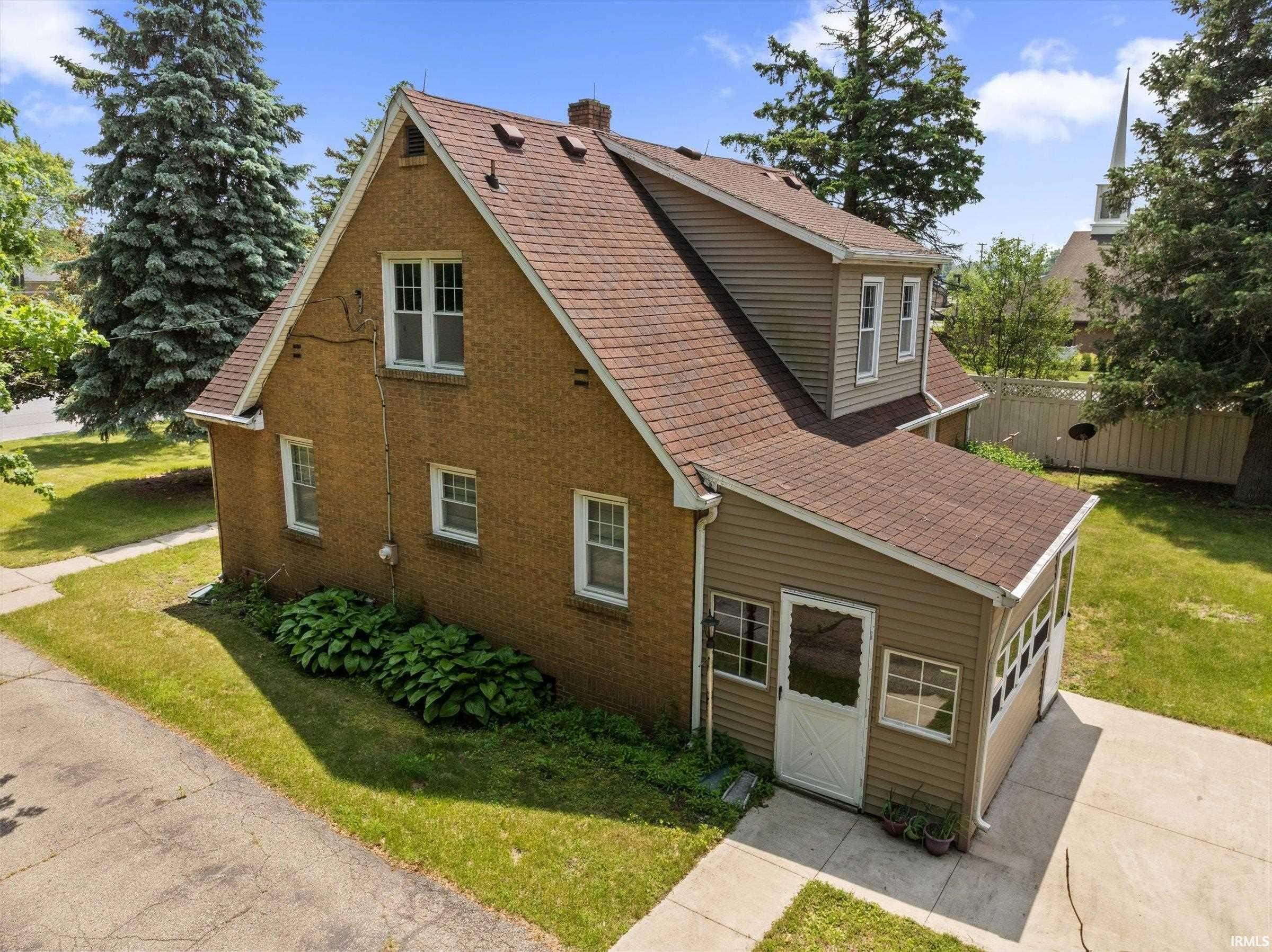 Brick and siding exterior with a brown shingle roof