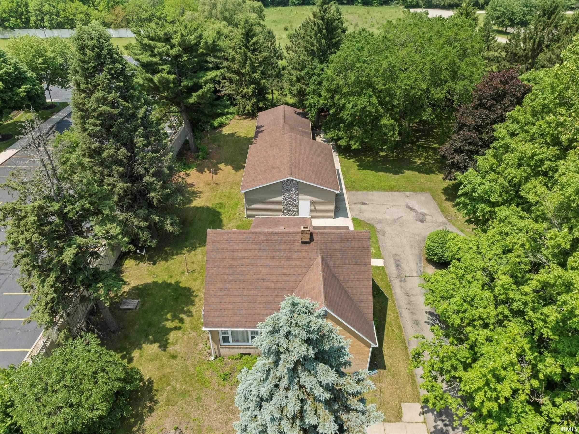 Expansive property featuring multiple structures with brown shingle roofing