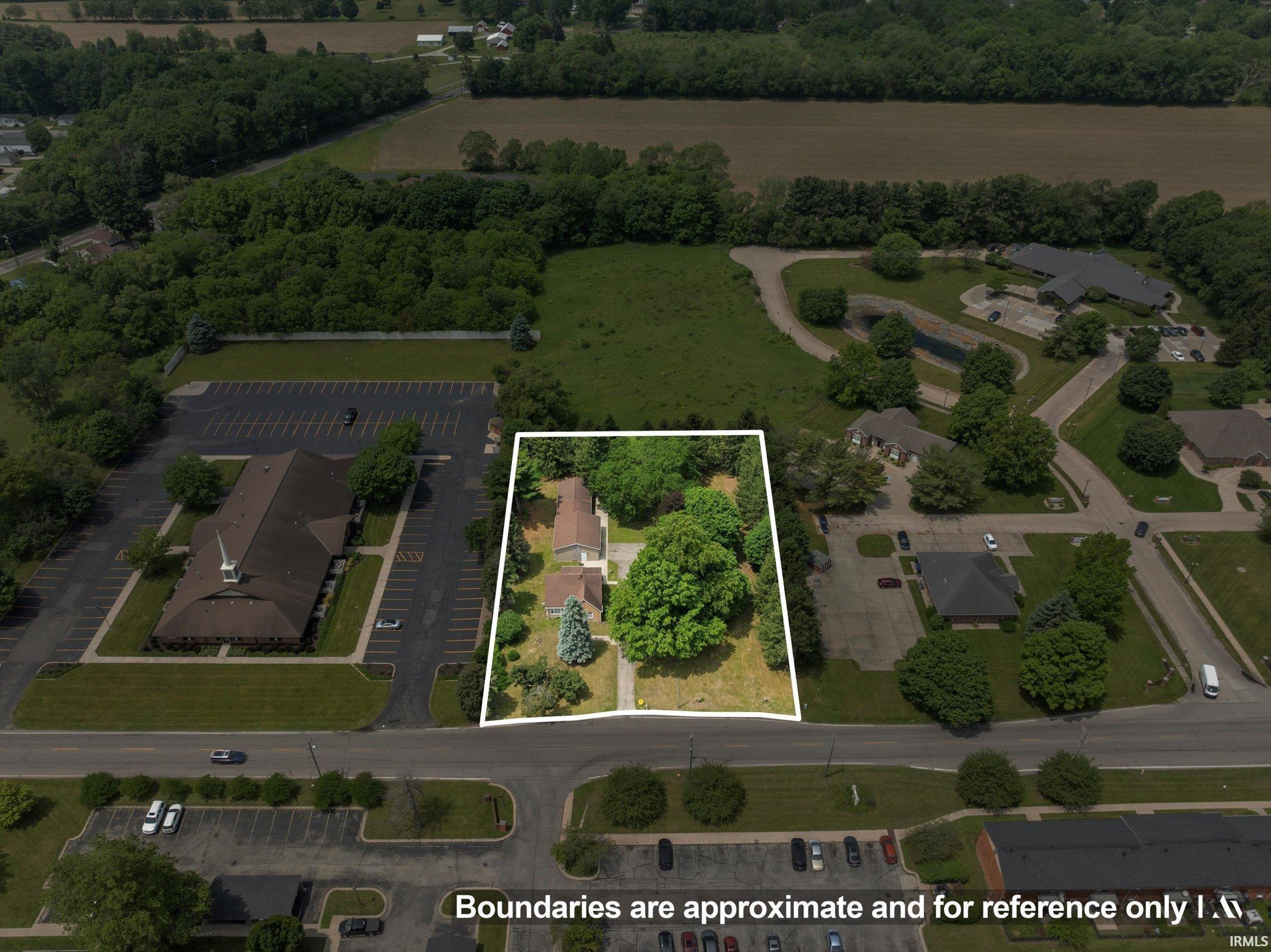 Expansive lot featuring mature trees and a residential structure