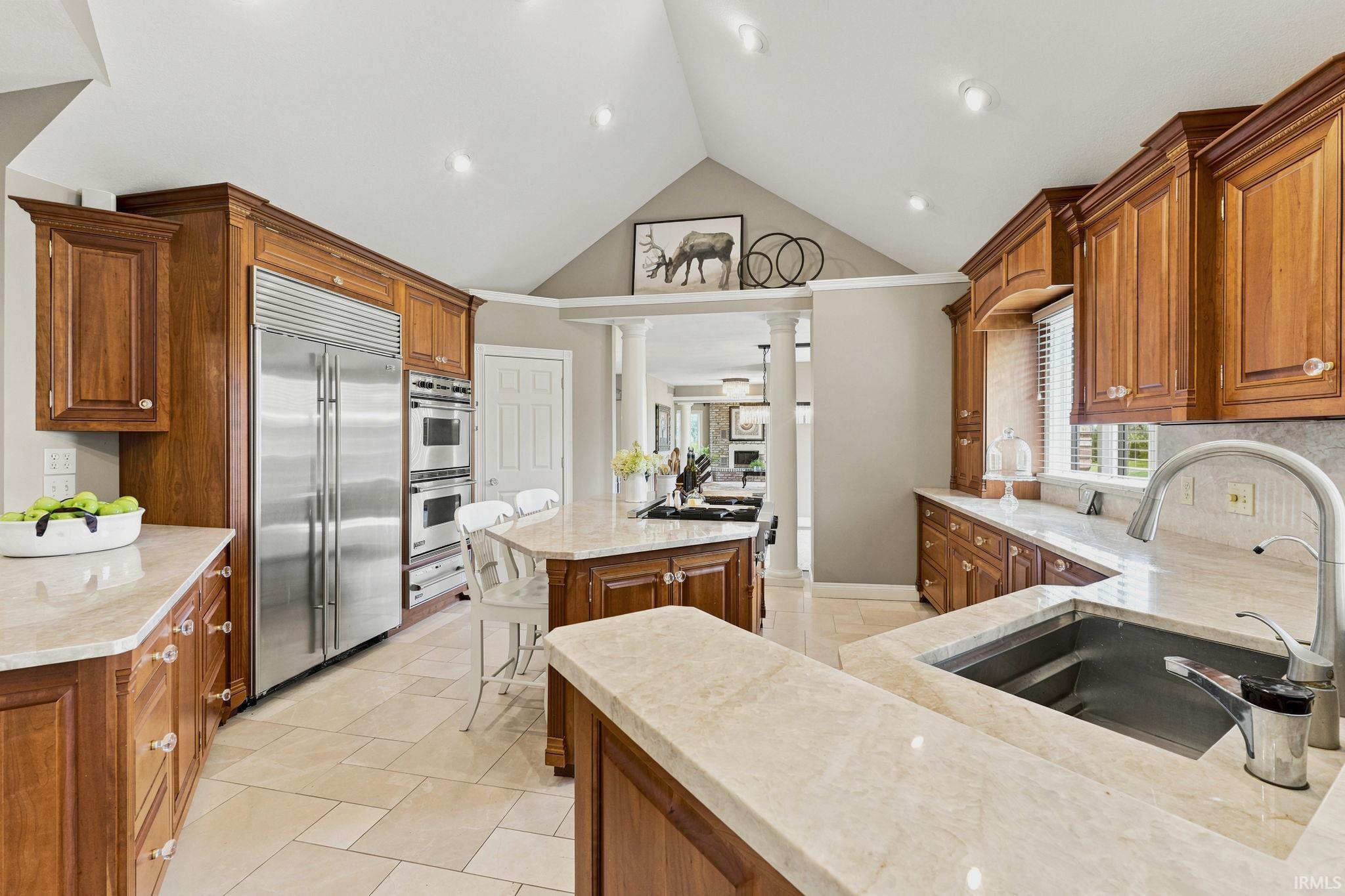 Gourmet kitchen featuring custom cabinetry and high end commercial appliances.