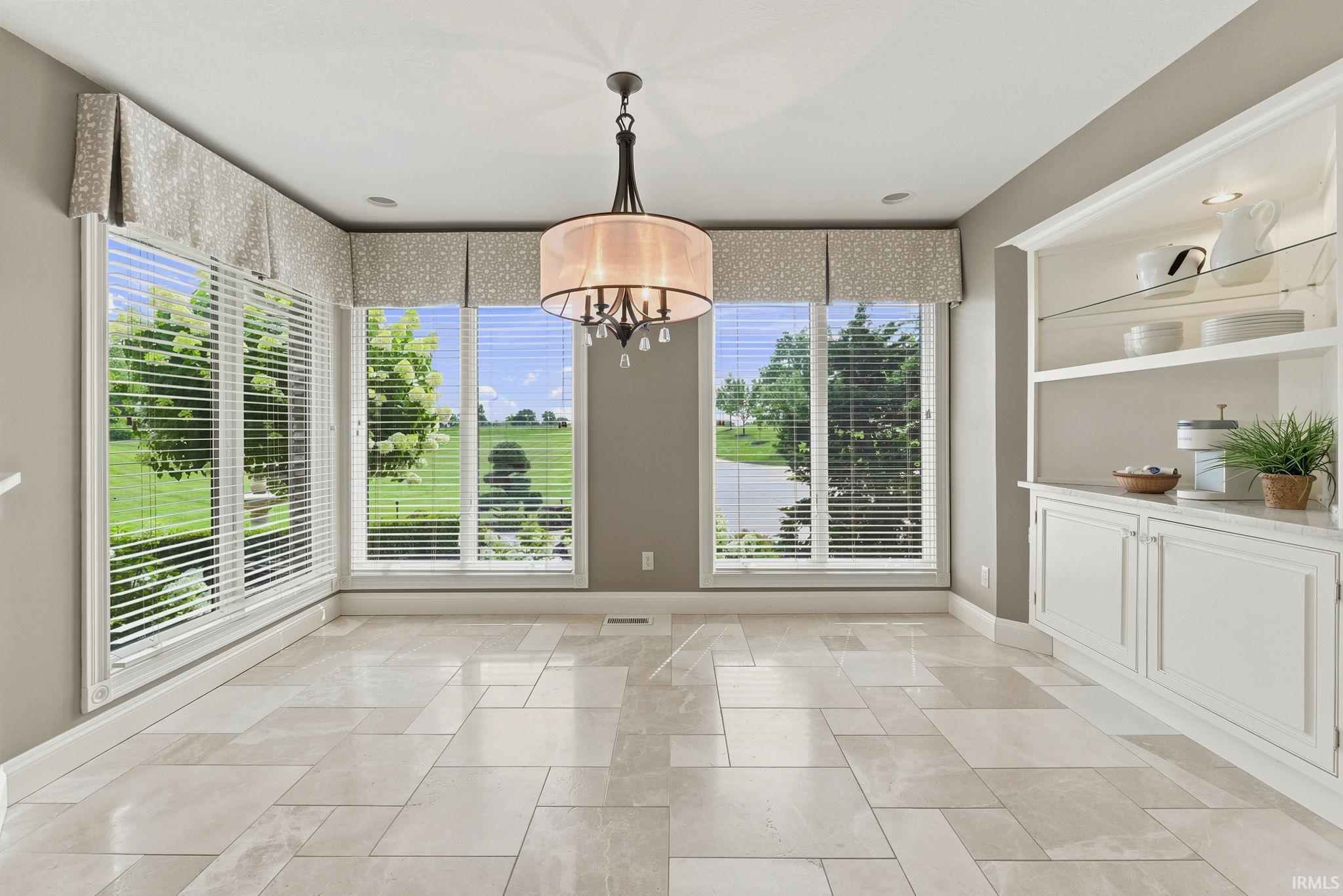 Inviting breakfast room with custom built-in storage and dedicated coffee bar.