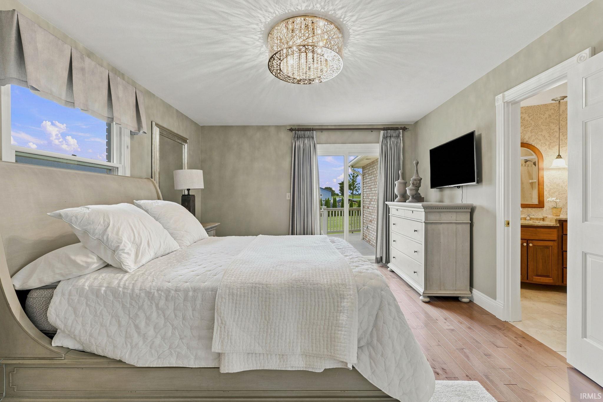 Two additional main-level bedrooms, including one with a private ensuite and another with convenient access to the hall bath.