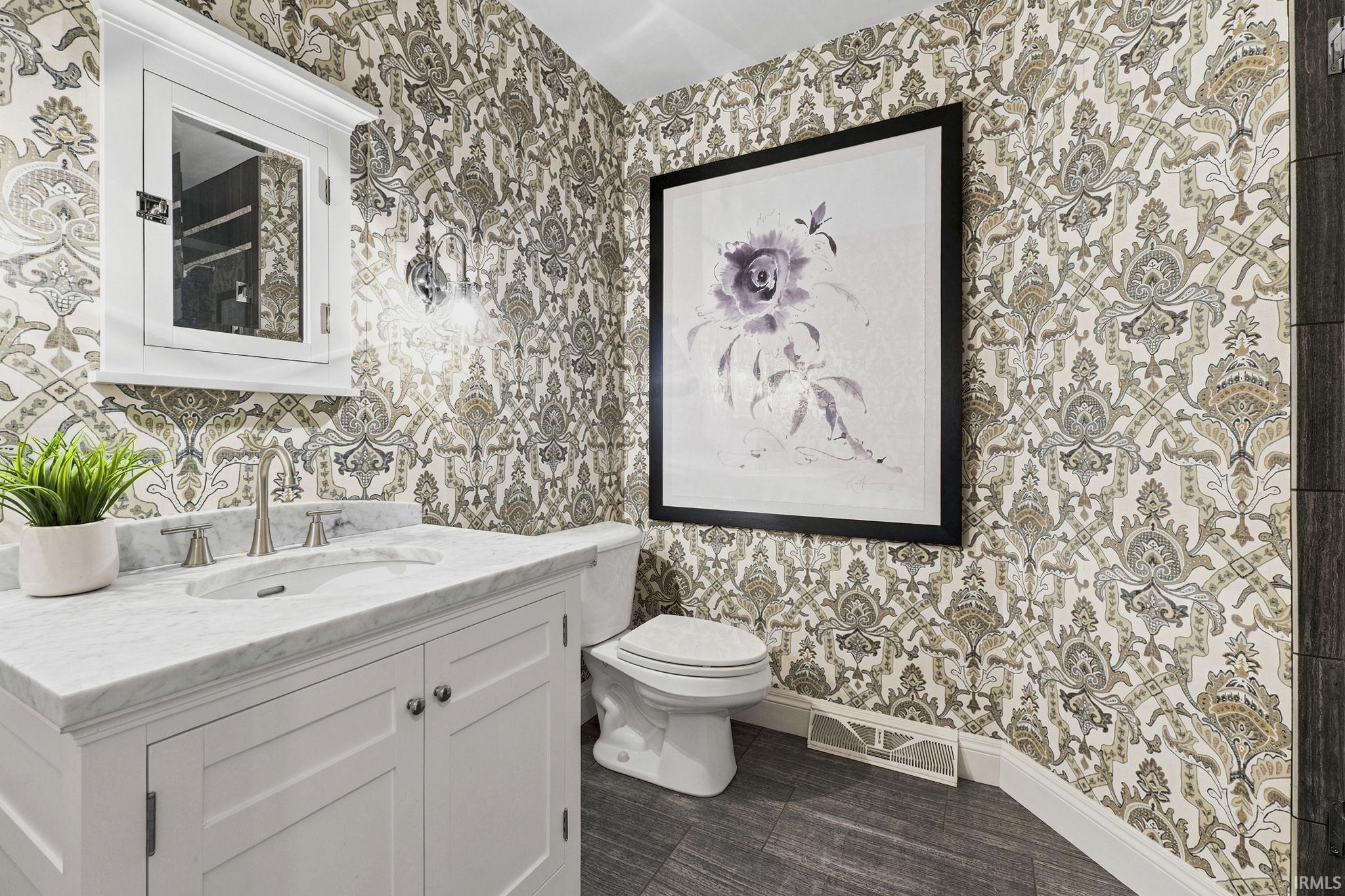 Well-appointed hall bathroom featuring a walk-in shower and custom built-in storage.