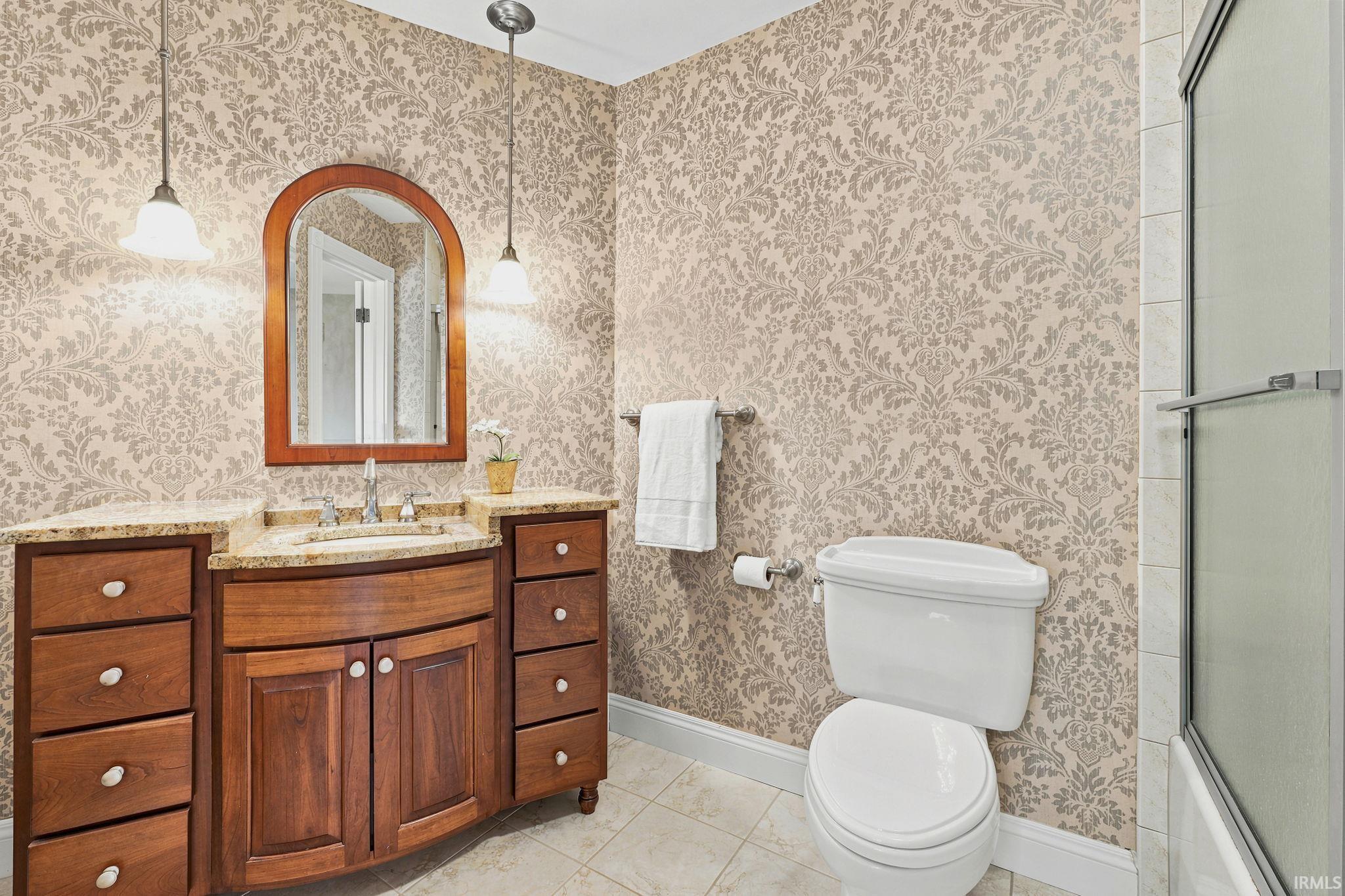 Private ensuite bathroom featuring thoughtful finishes and convenient functionality.