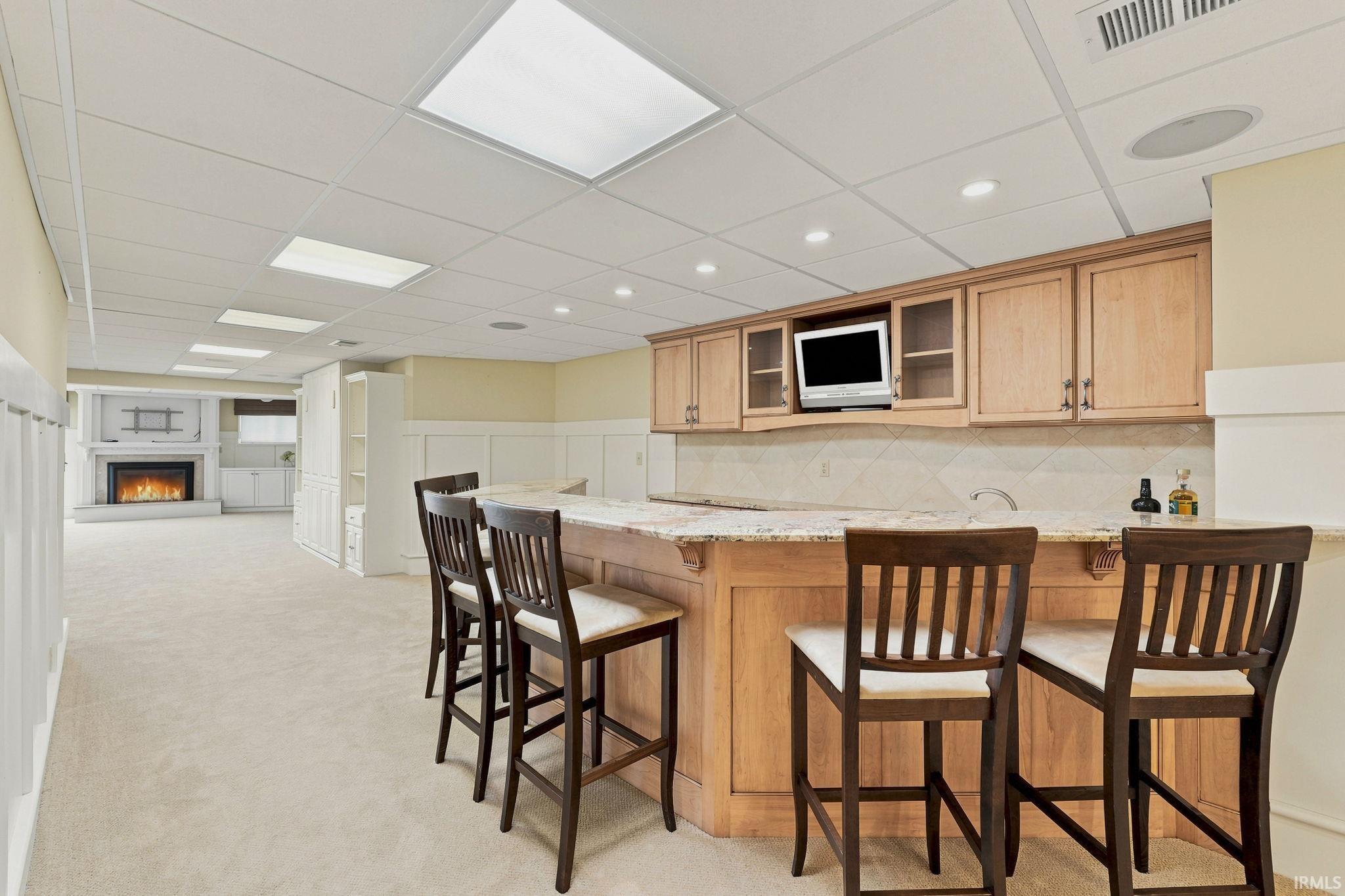 Lower-level bar designed for entertaining and gathering