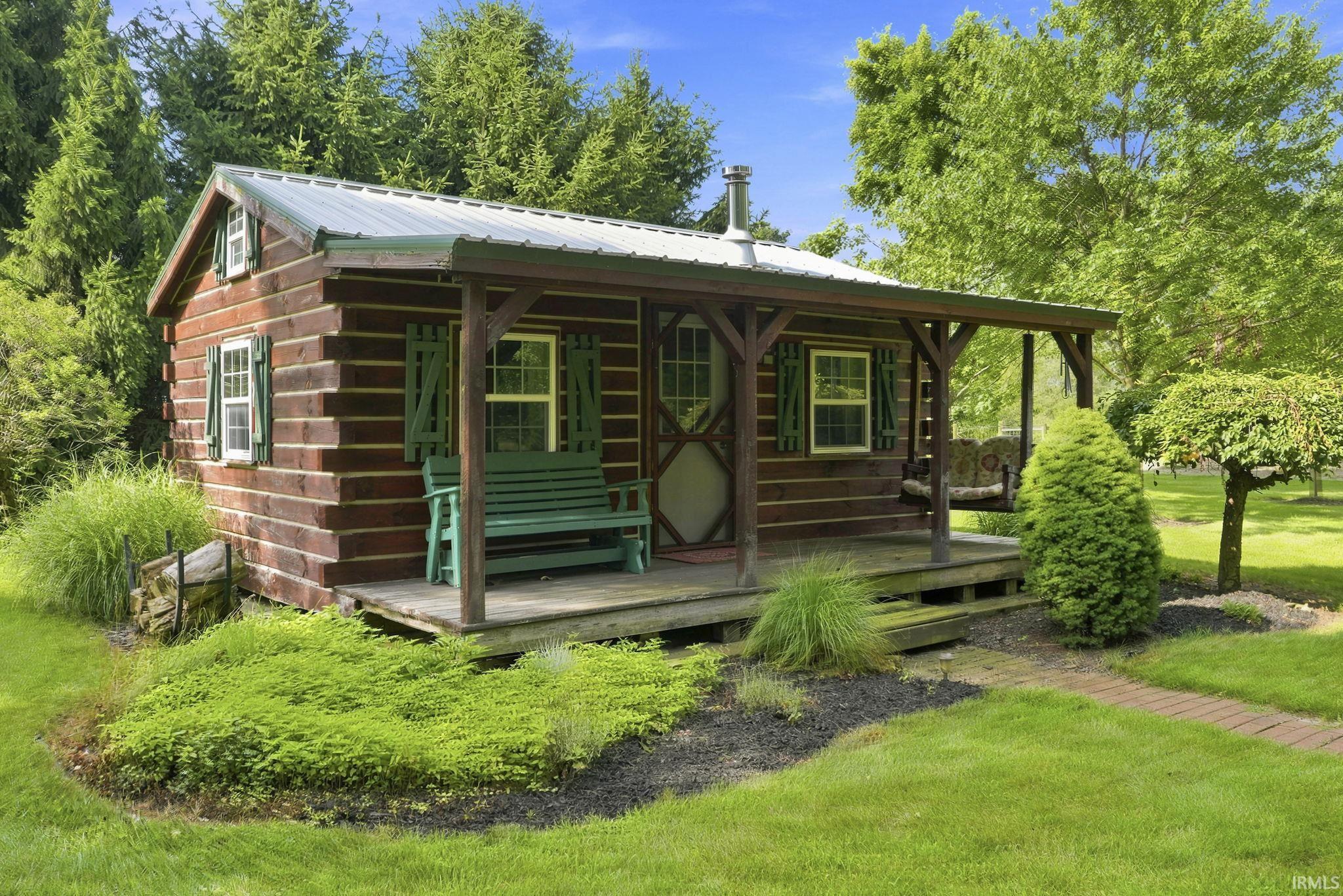 Amish-built log cabin nestled in the backyard, offering a peaceful private retreat surrounded by nature.