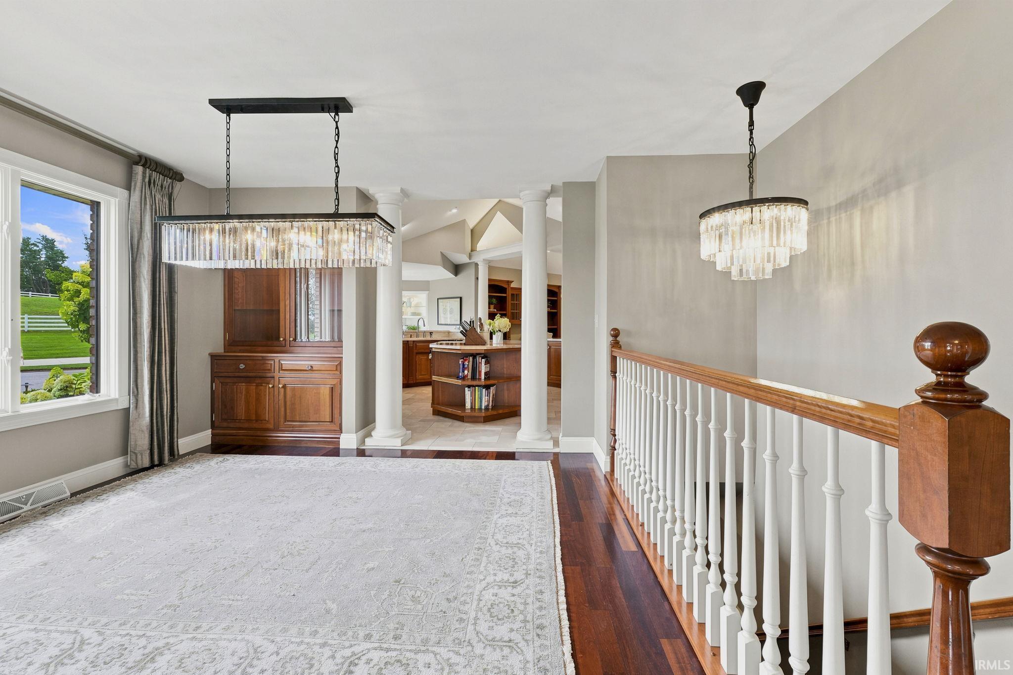 Elegant formal dining room featuring built-in china hutches and Restoration Hardware lighting.