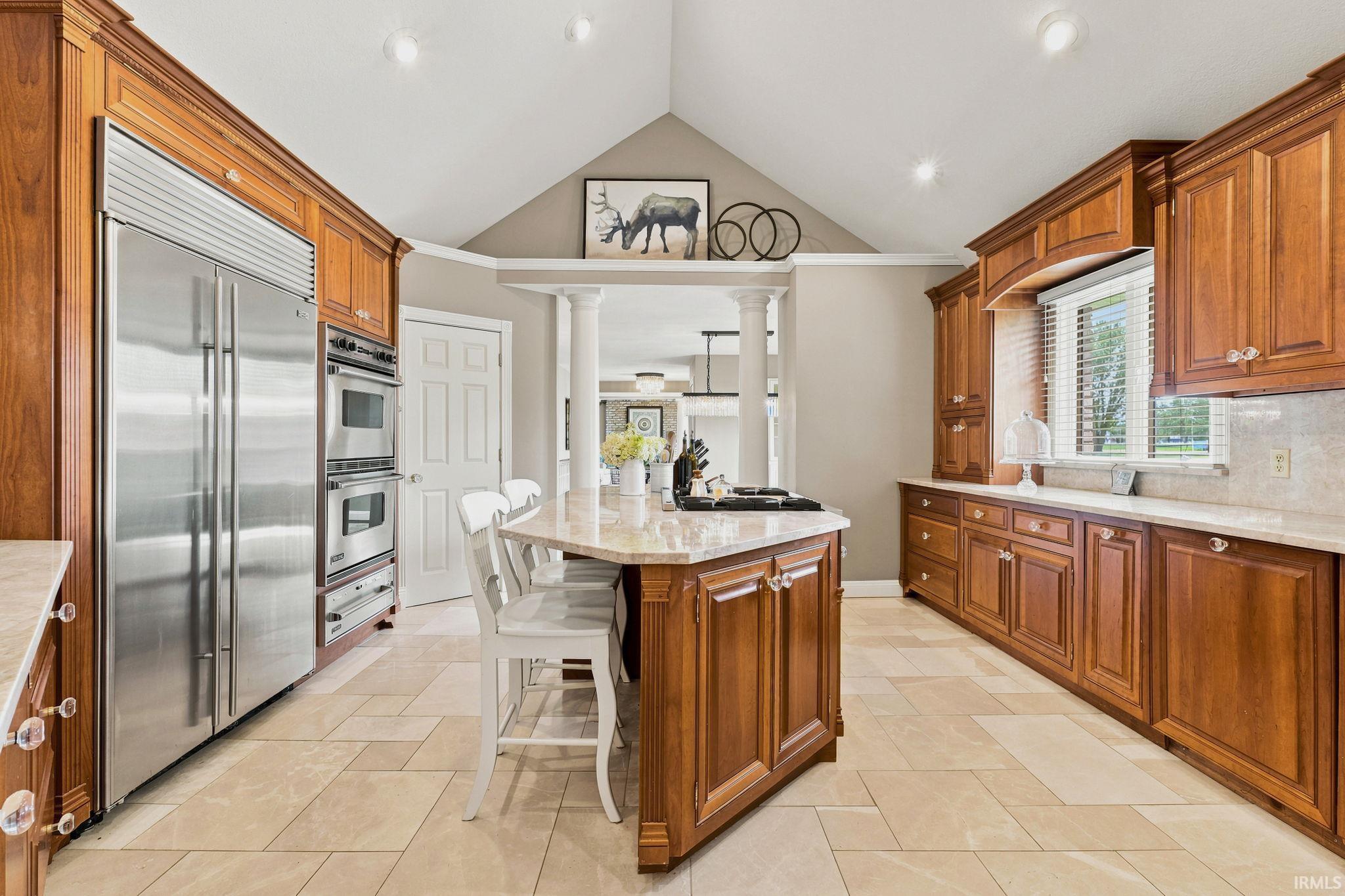 Gourmet kitchen featuring custom cabinetry and high end commercial appliances.