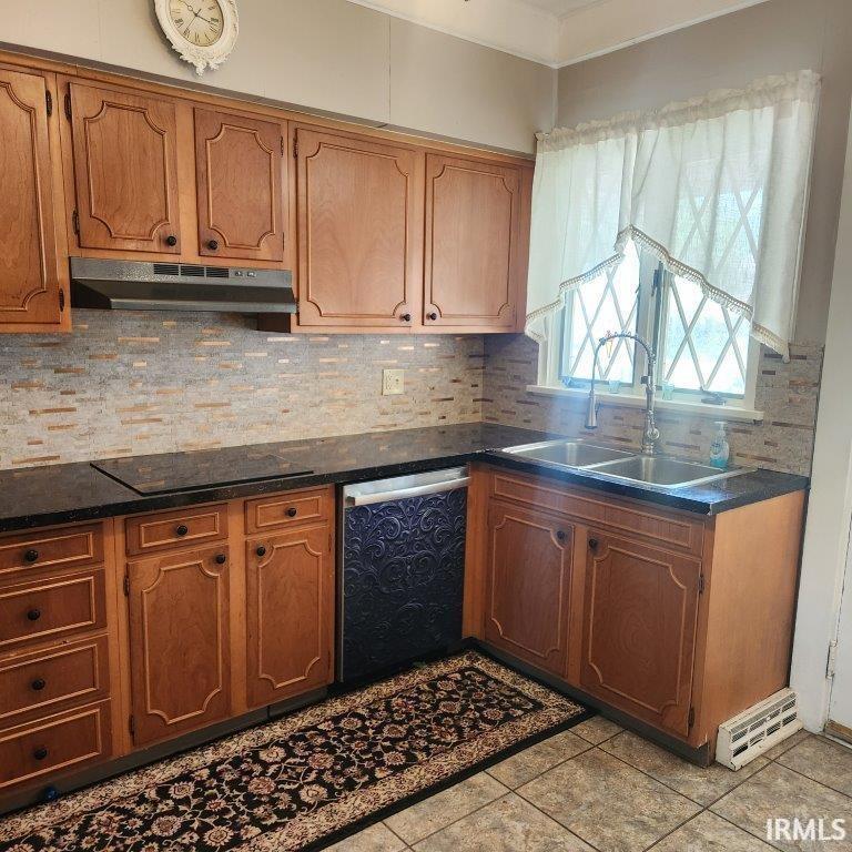 Kitchen featuring tasteful backsplash, stainless steel dishwasher, brown cabinetry, and under cabinet range hood