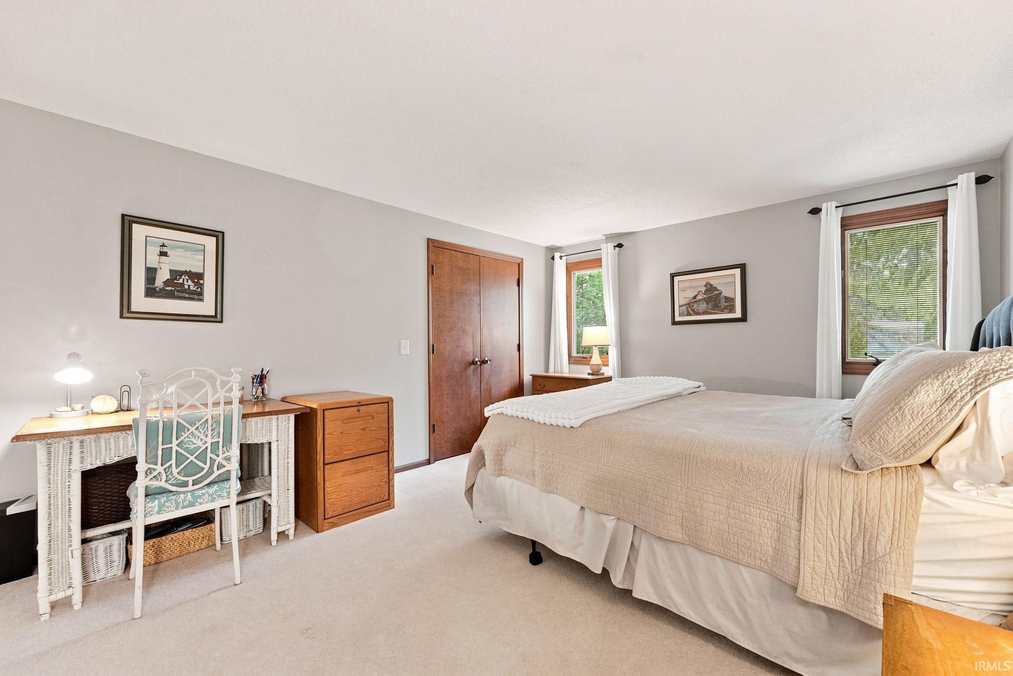 Neutral-toned room featuring light gray walls and plush carpeting