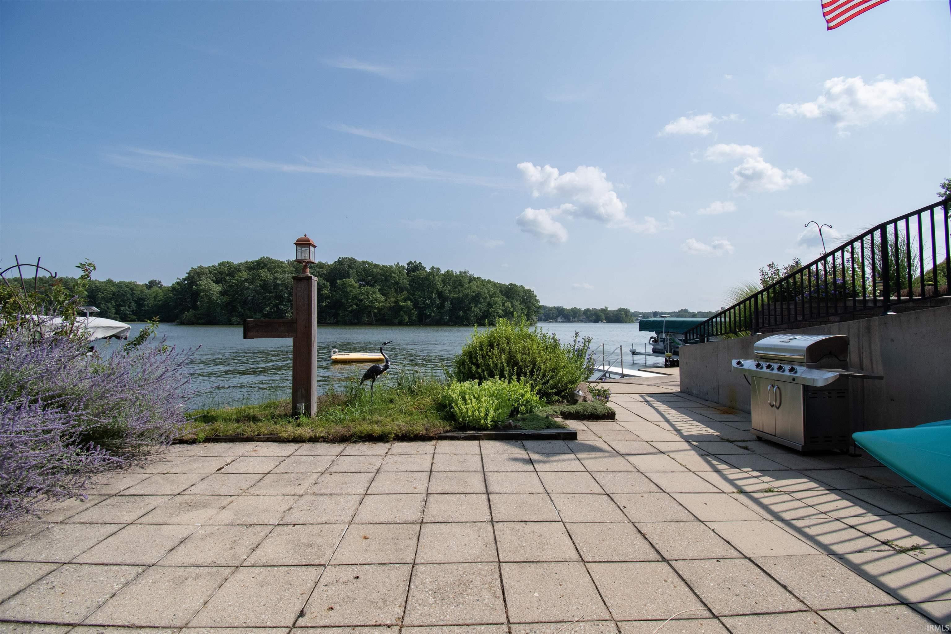 Expansive paver patio offering waterfront access