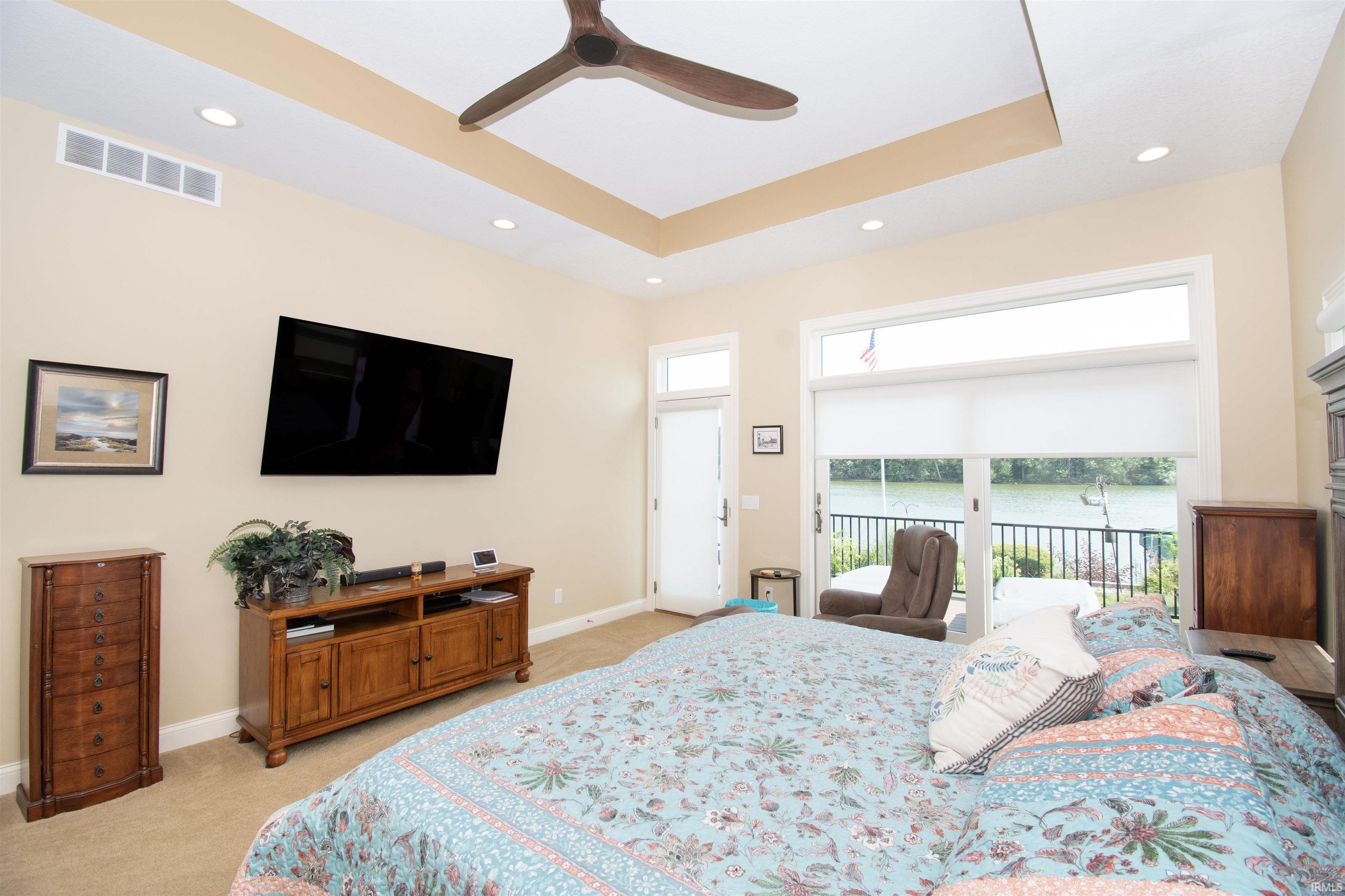 Bedroom with tray ceiling and recessed lighting
