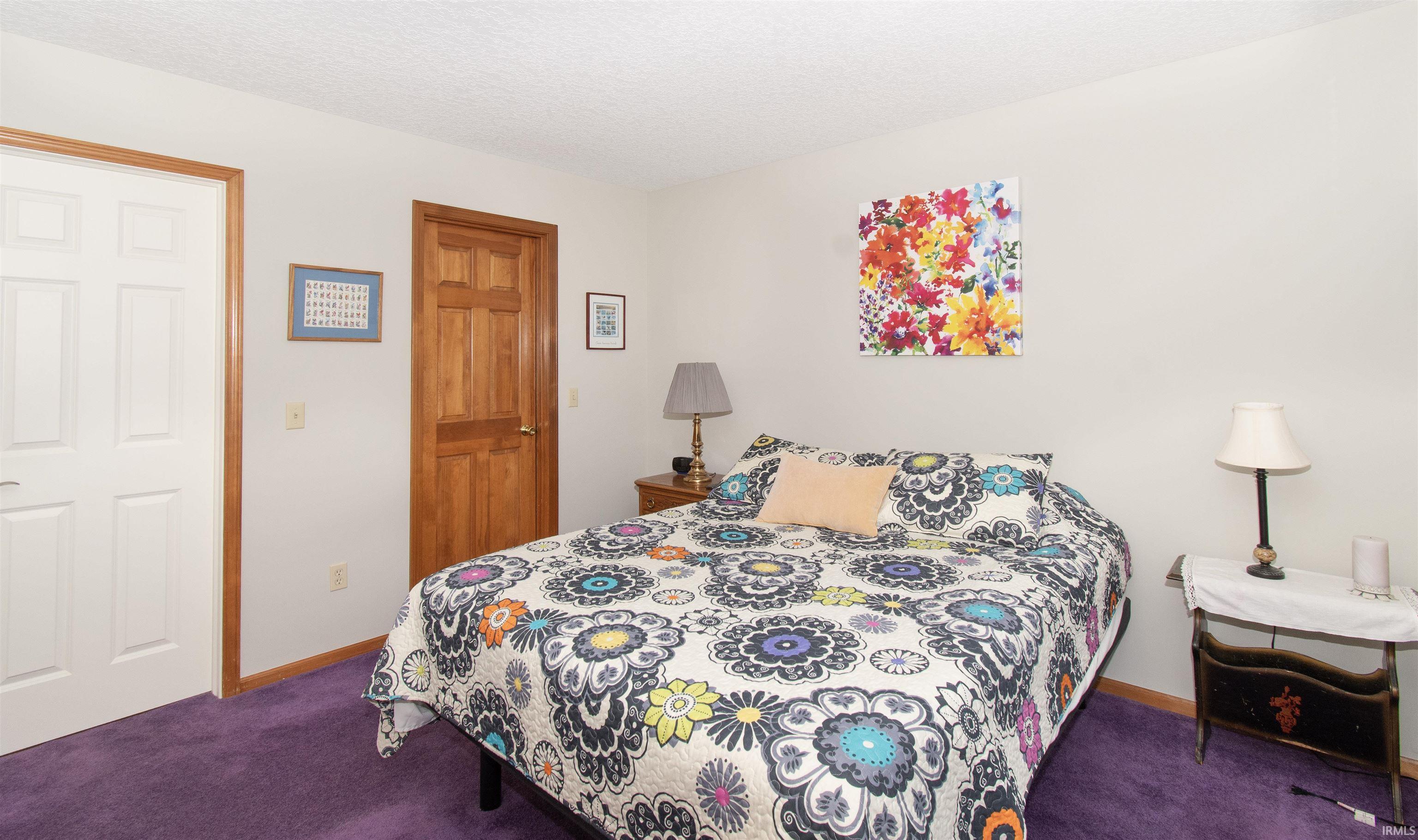 Plush purple carpeting complements light-colored walls
