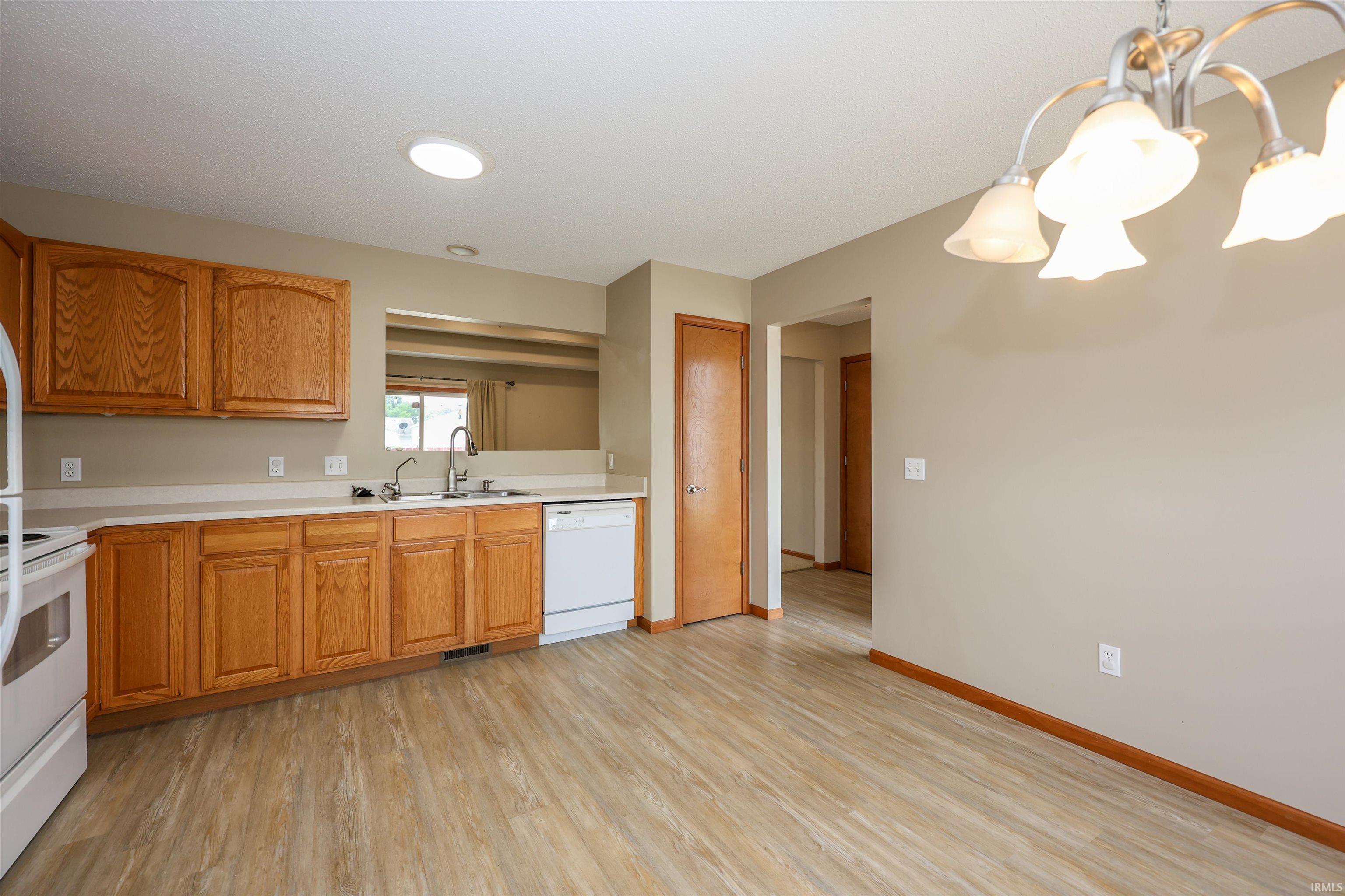 Kitchen and dining area featuring wood-finish flooring