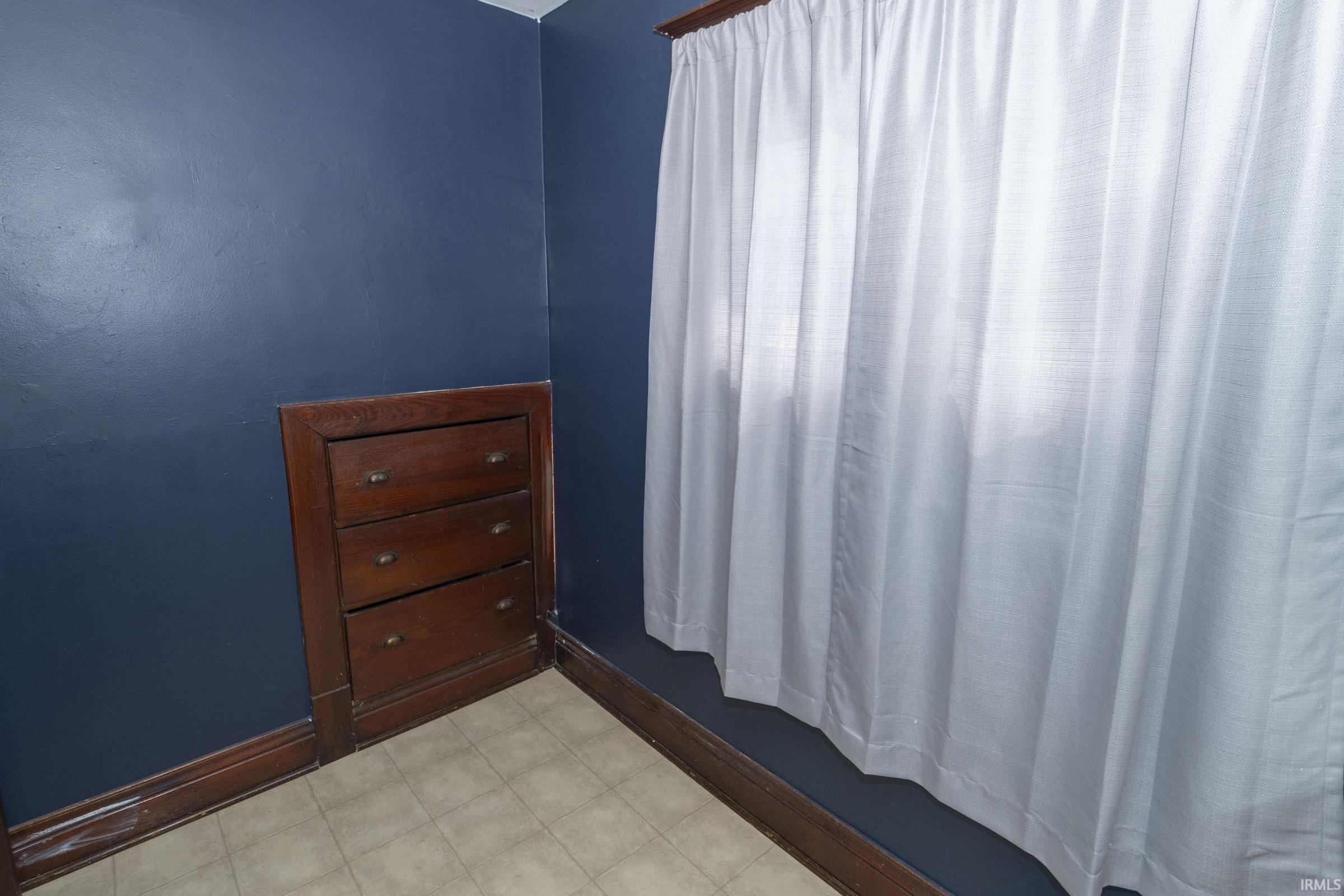 Built-in wood cabinetry with three drawers and dark hardware, complemented by dark wood trim