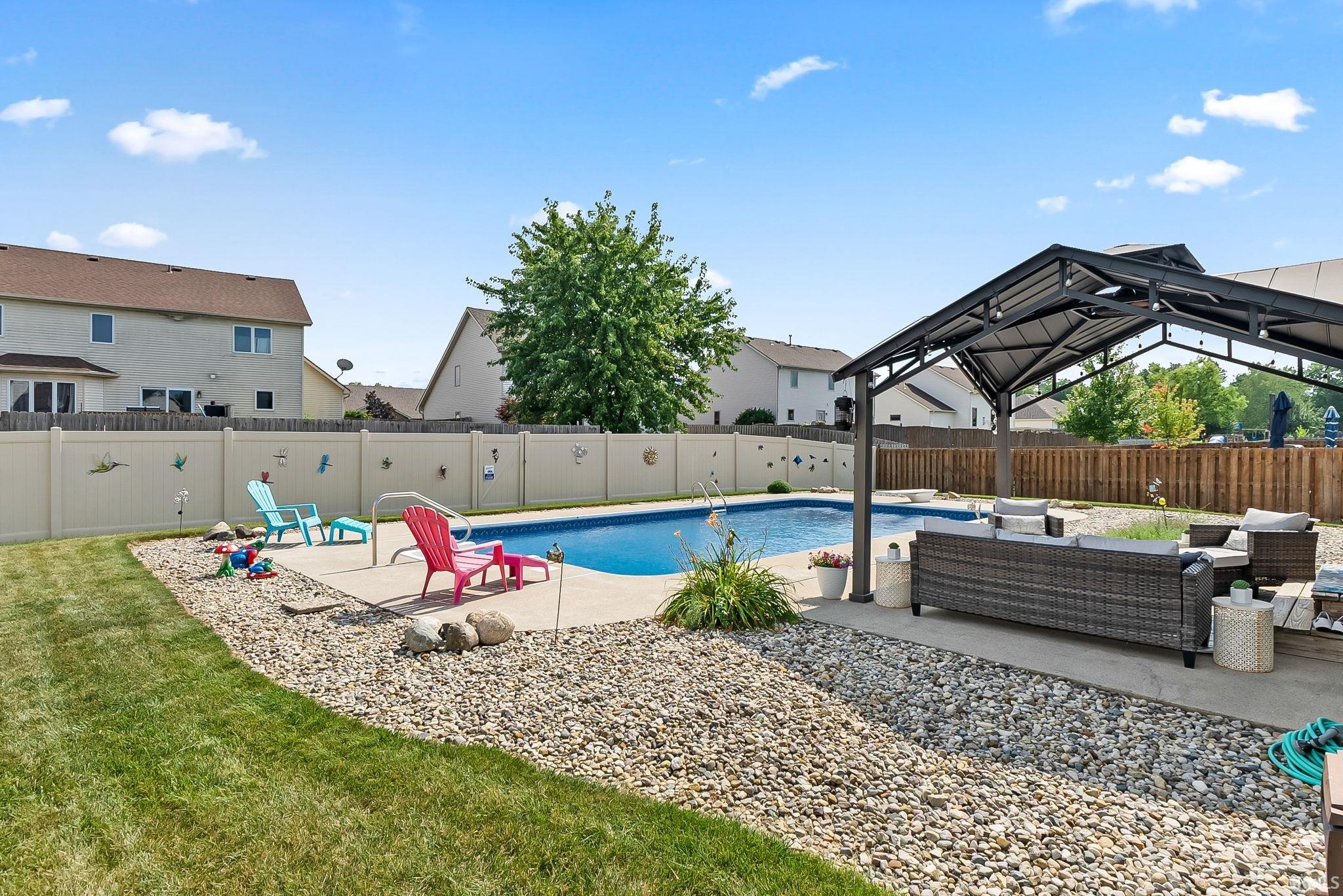 In-ground swimming pool with a concrete surround
