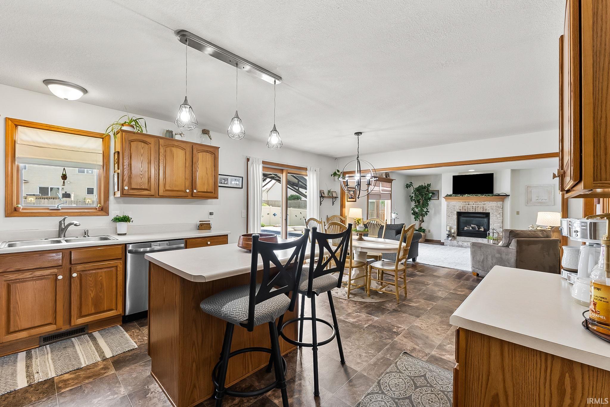 Kitchen featuring wood cabinetry, stainless steel appliances, and an island with seating
