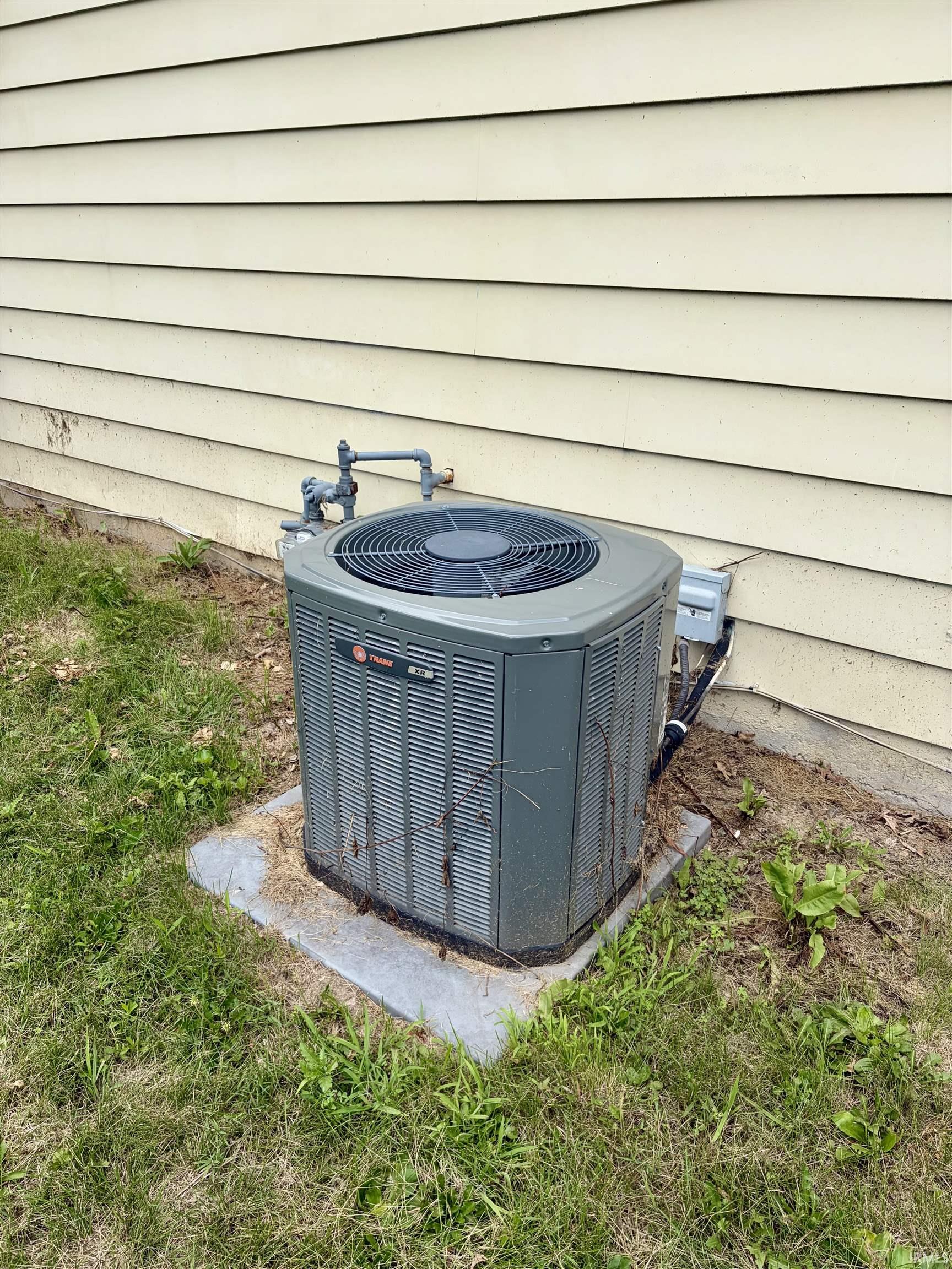 Exterior mechanical unit on a concrete pad with a gas line connection