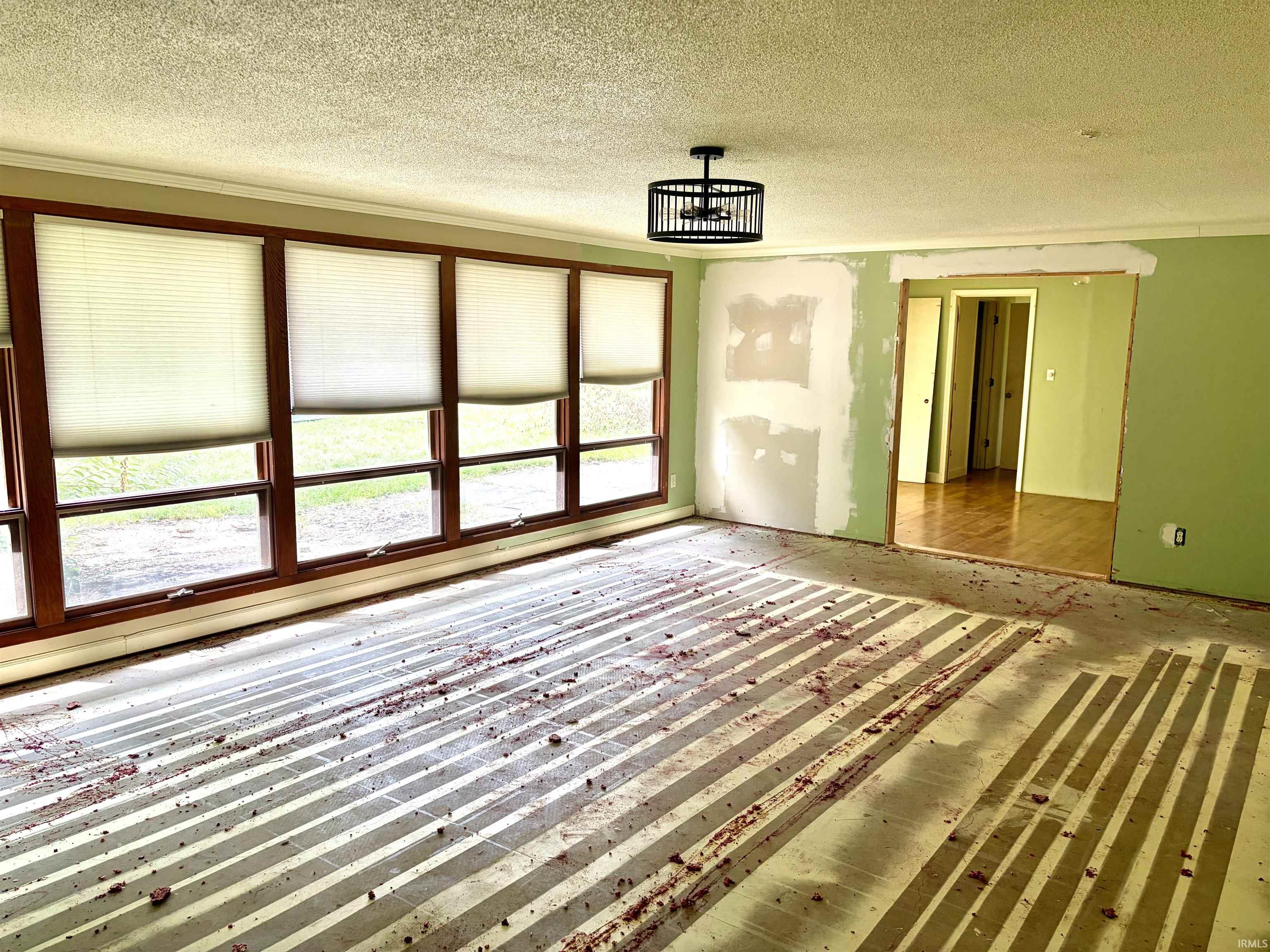 Expansive wall of windows featuring wood-finish framing and light-filtering blinds