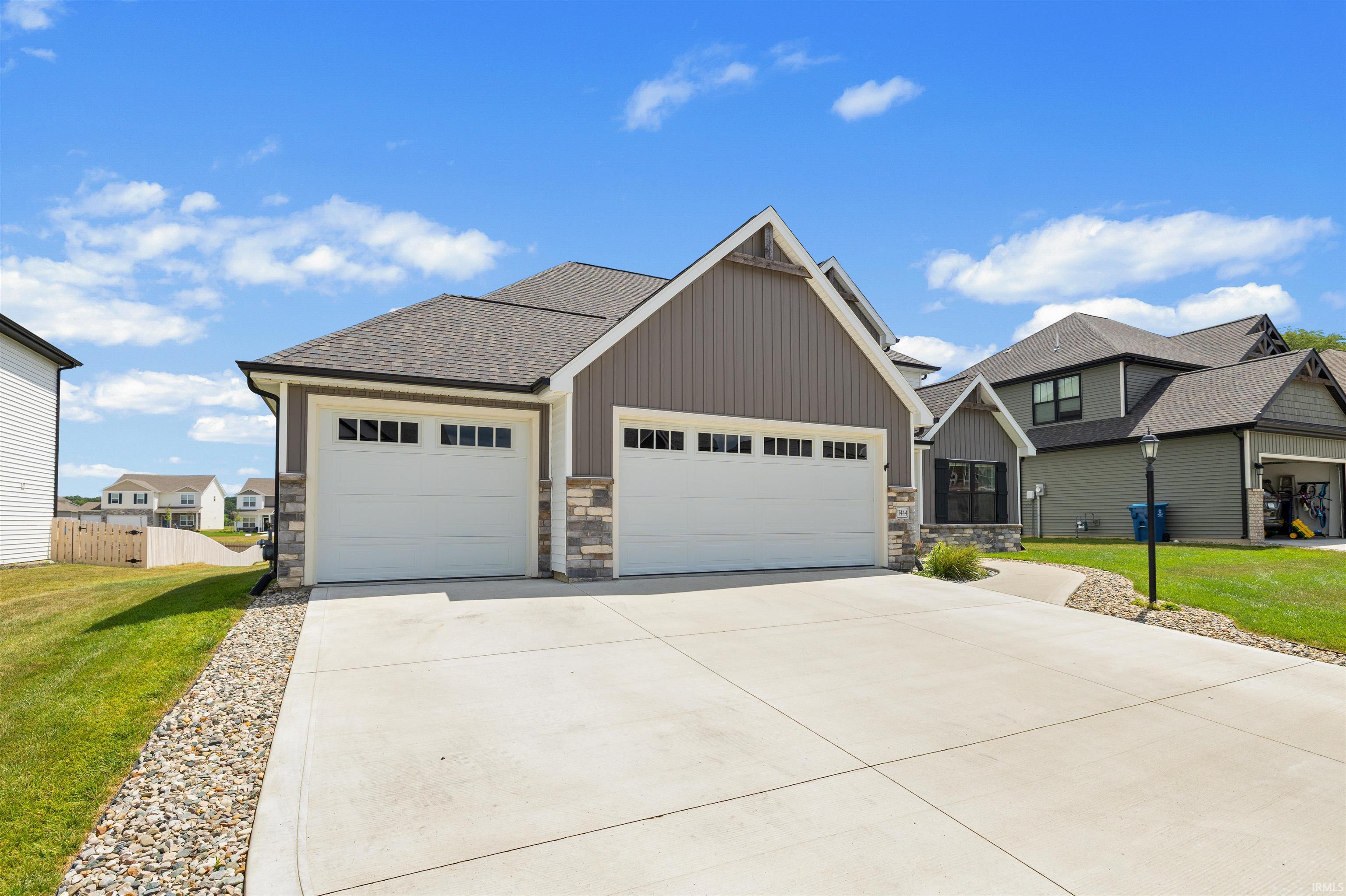 Contemporary home exterior featuring vertical siding and stone accents