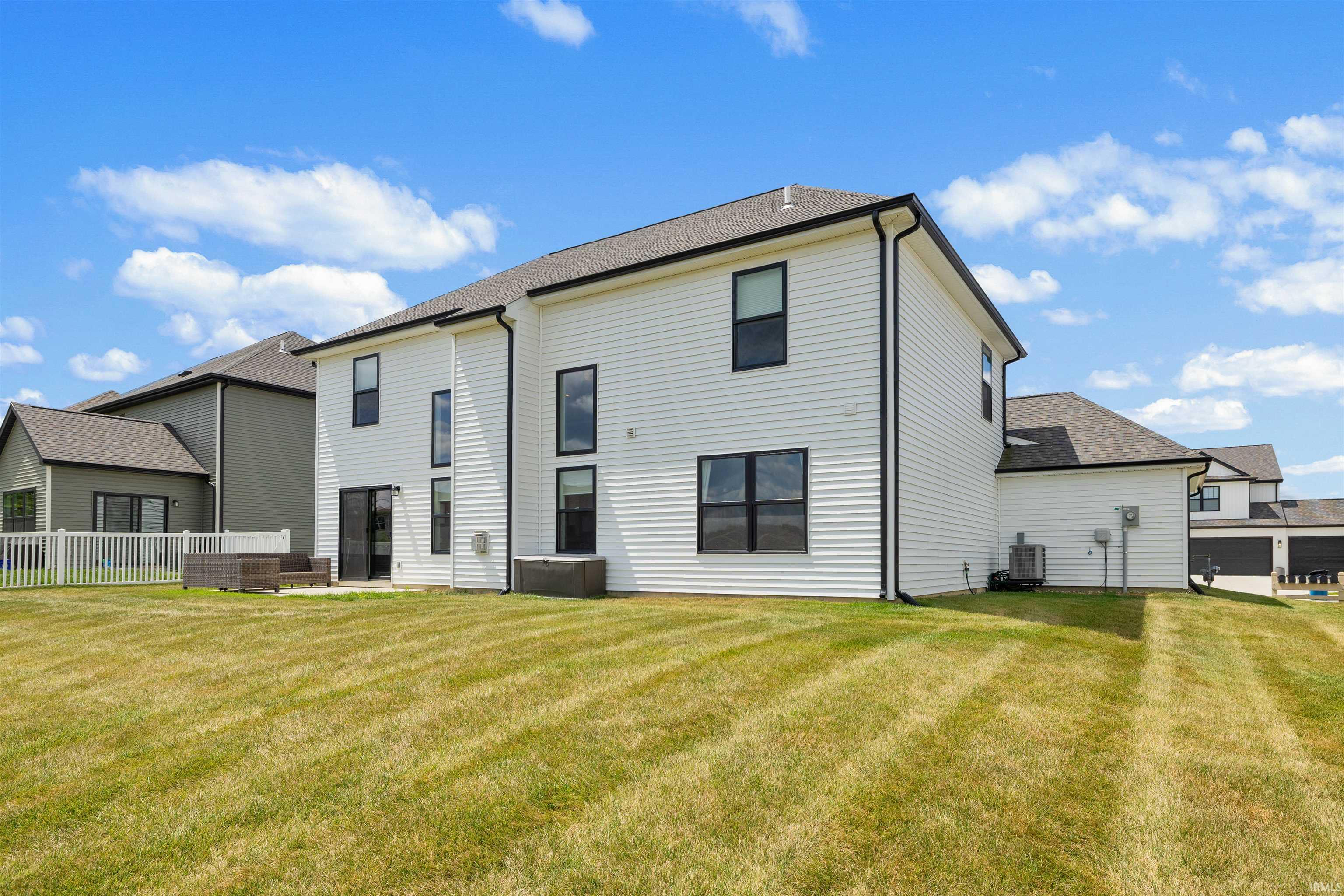 Spacious rear yard with a concrete patio