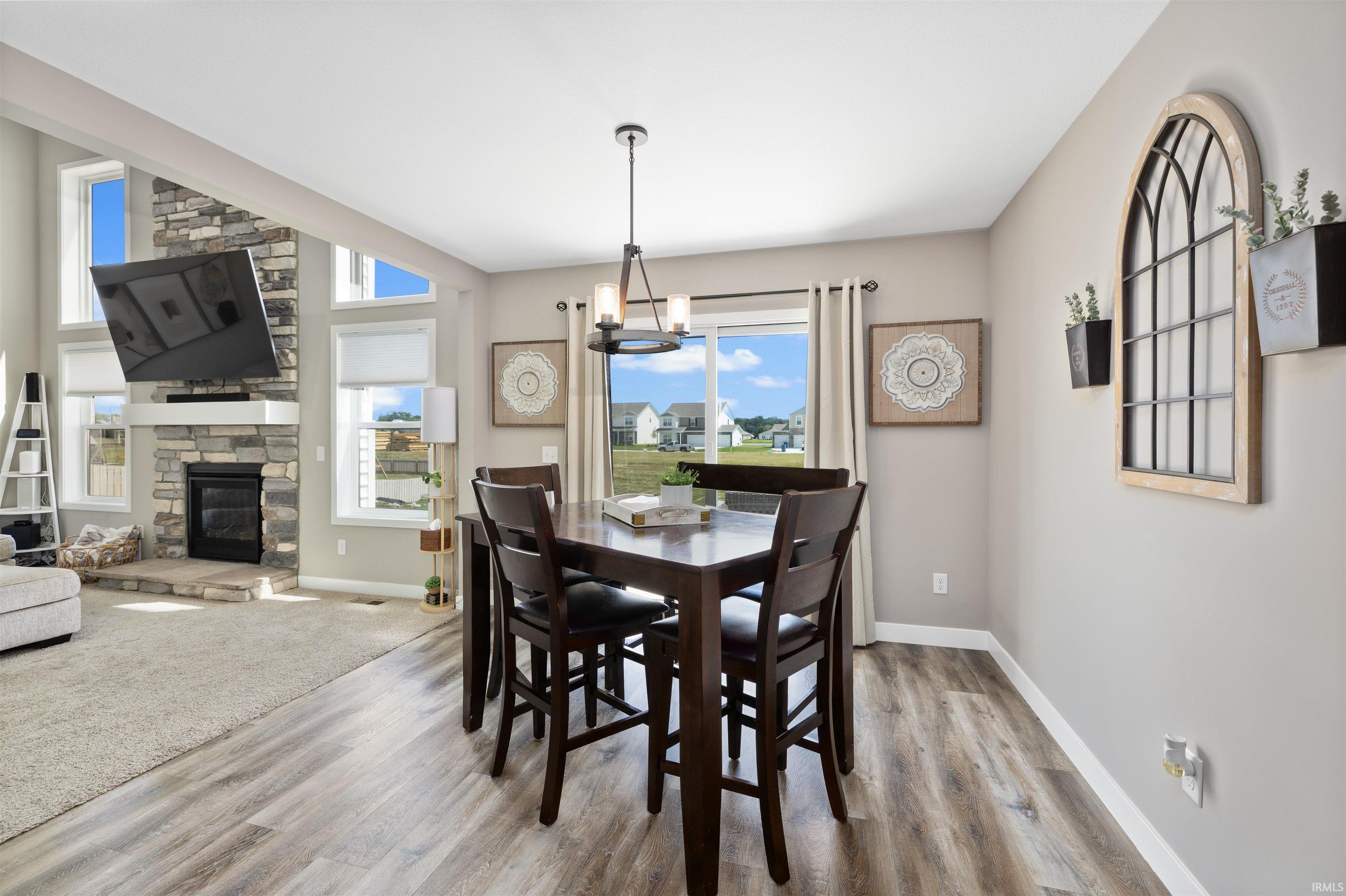 Open-concept dining area featuring wood-finish flooring